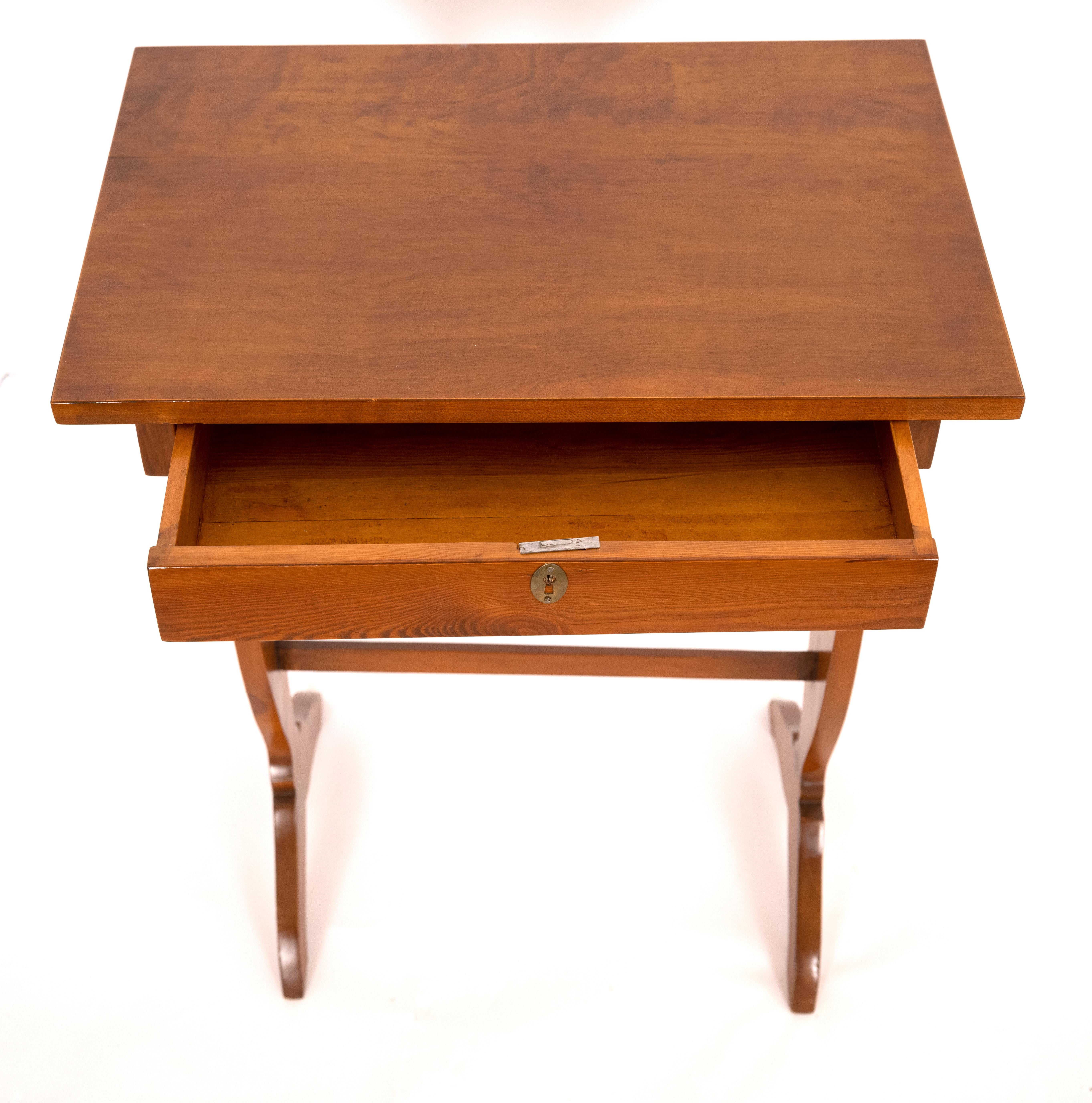 A Swedish Birch side table with a shallow drawer. The baluster shaped sides joined by aproned stretcher. circa 1900s.