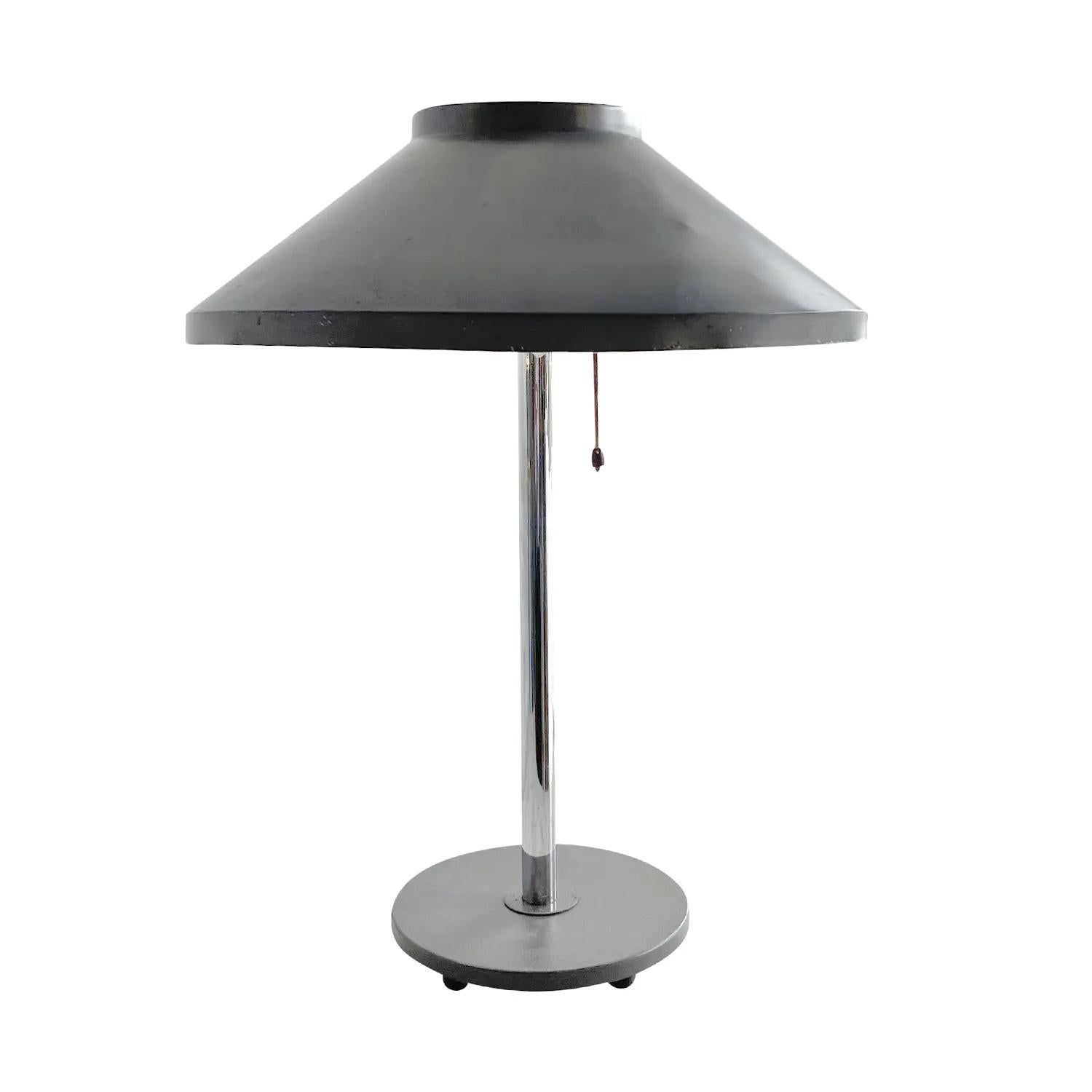 A vintage Mid-Century Modern Swedish table luminaire, lamp made of hand crafted chrome with a round grey sheet metal shade, designed and produced by Falkenbergs Belysning in good condition. The Scandinavian desk light is featuring a one light