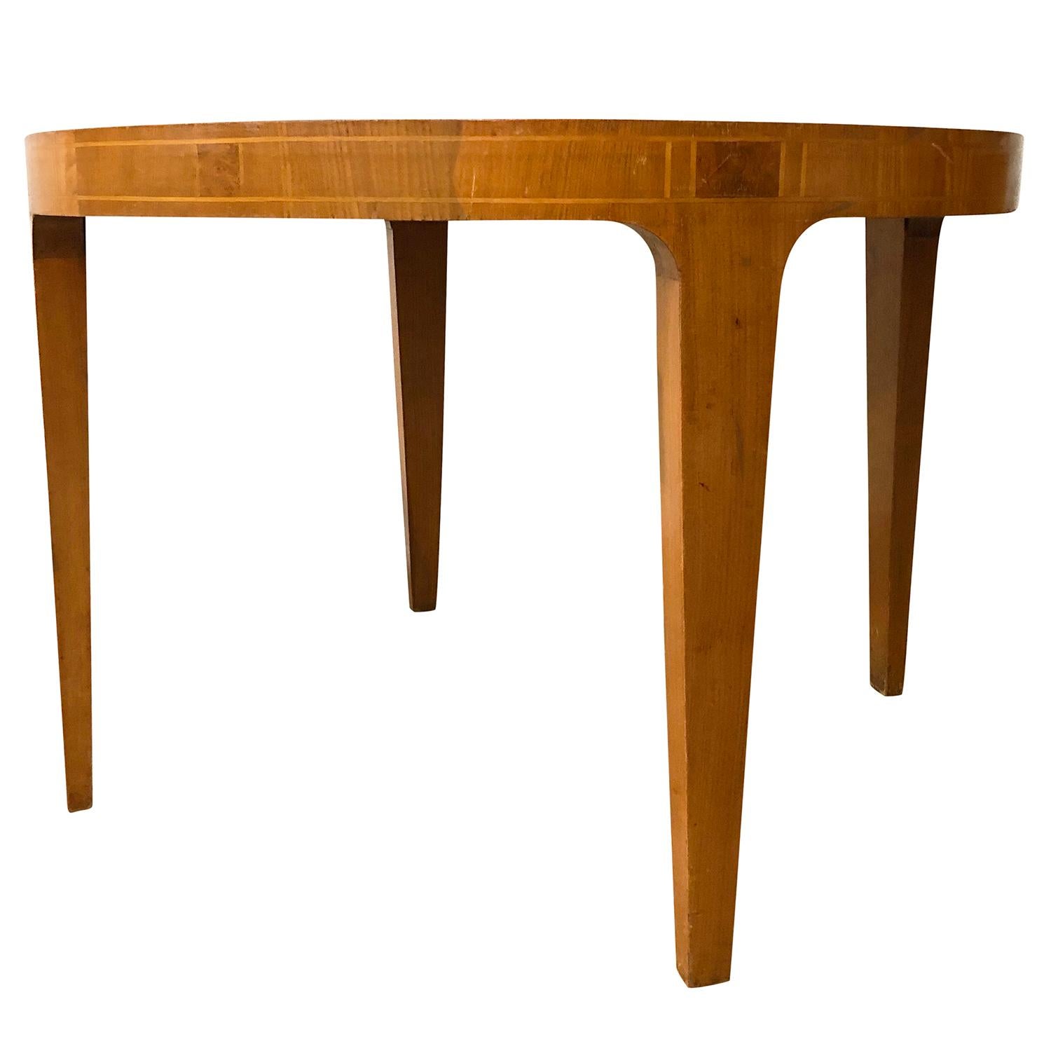 A small, round vintage Mid-Century modern Swedish sofa table made of hand crafted Maplewood and Birchwood, in good condition. The detailed Scandinavian side table is enhanced by wood inlays, standing on four straight wooden legs. Minor fading,