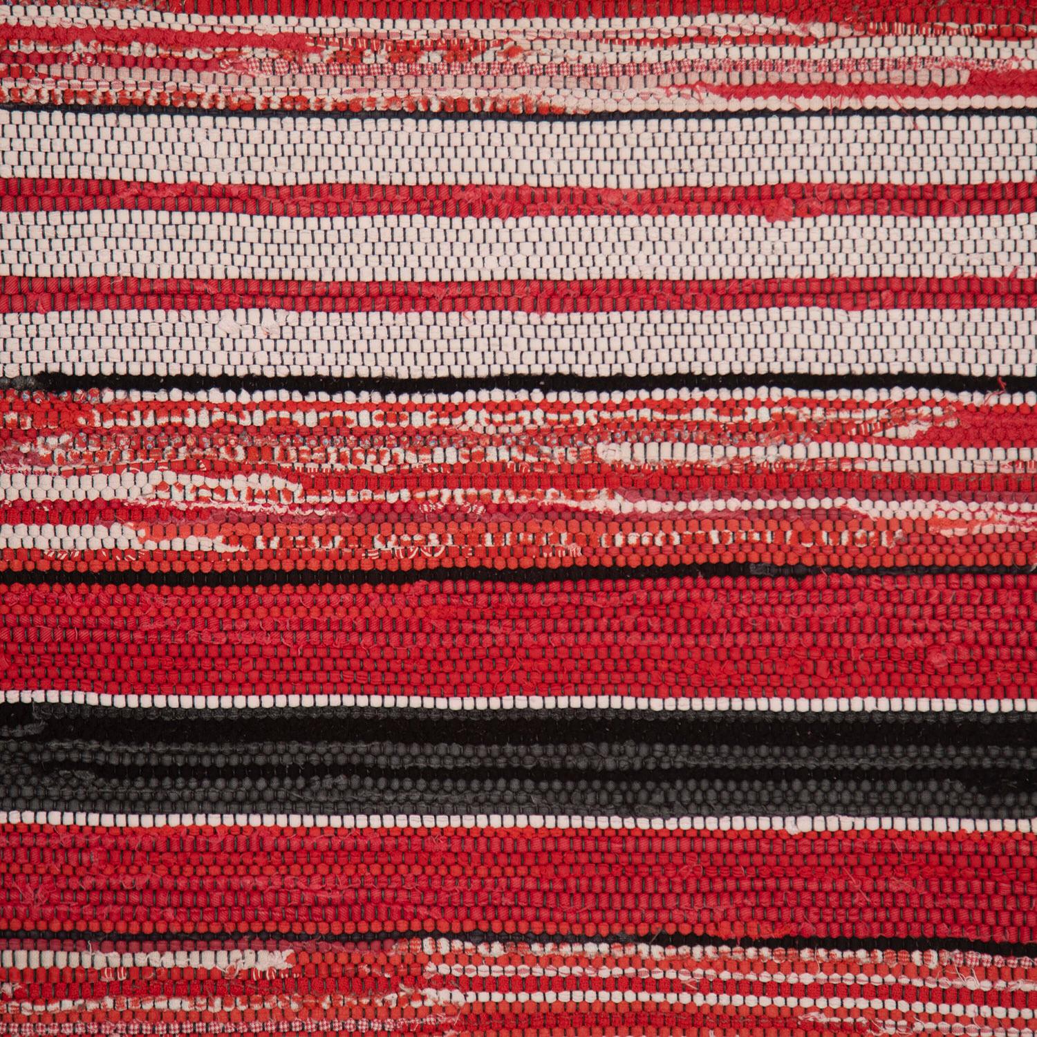 Striking Swedish handwoven rag rug, circa 1940-50. 

This rug has a slim form and ideal proportions for a bedroom or small hallway runner. 

It features a boldly striped design in a colour palette of vivid red and monochrome. 

A wonderful way