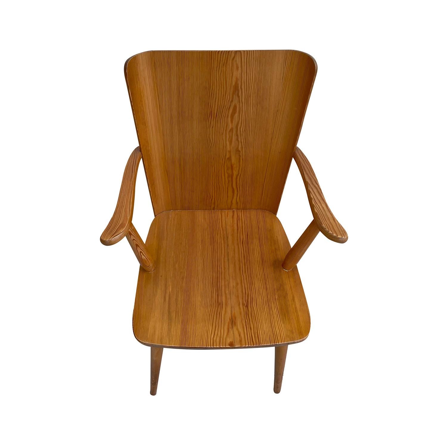 A light-brown, vintage Mid-Century Modern Swedish Fur, armchair made of hand carved and polished Pinewood, designed by Göran Malmvall and produced by Karl Andersson & Söner, in good condition. The backrest of the single Scandinavian side, end chair