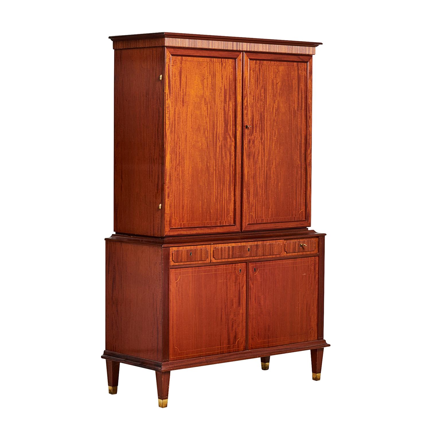 A vintage Mid-Century modern Swedish serving cabinet made of hand crafted polished, partly veneered Walnut and Mahogany, in good condition. The upper section features two paneled doors that open to reveal four adjustable shelfs, all detailed with