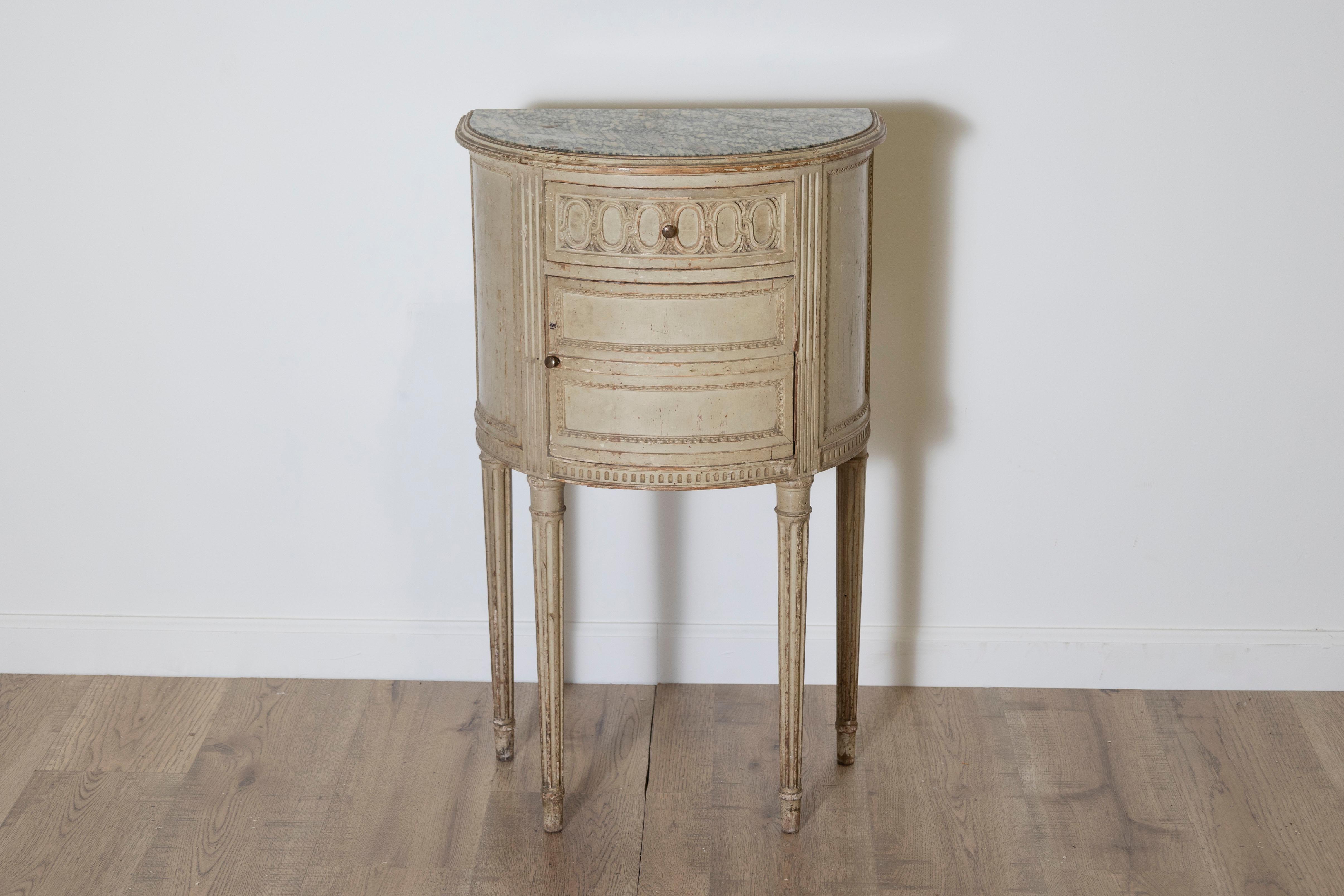 This elegant 20th-century Swedish nightstand features a refined design with a marble top, showcasing the timeless appeal of Scandinavian craftsmanship. The semi-circular silhouette is adorned with intricate carved detailing along the edges,