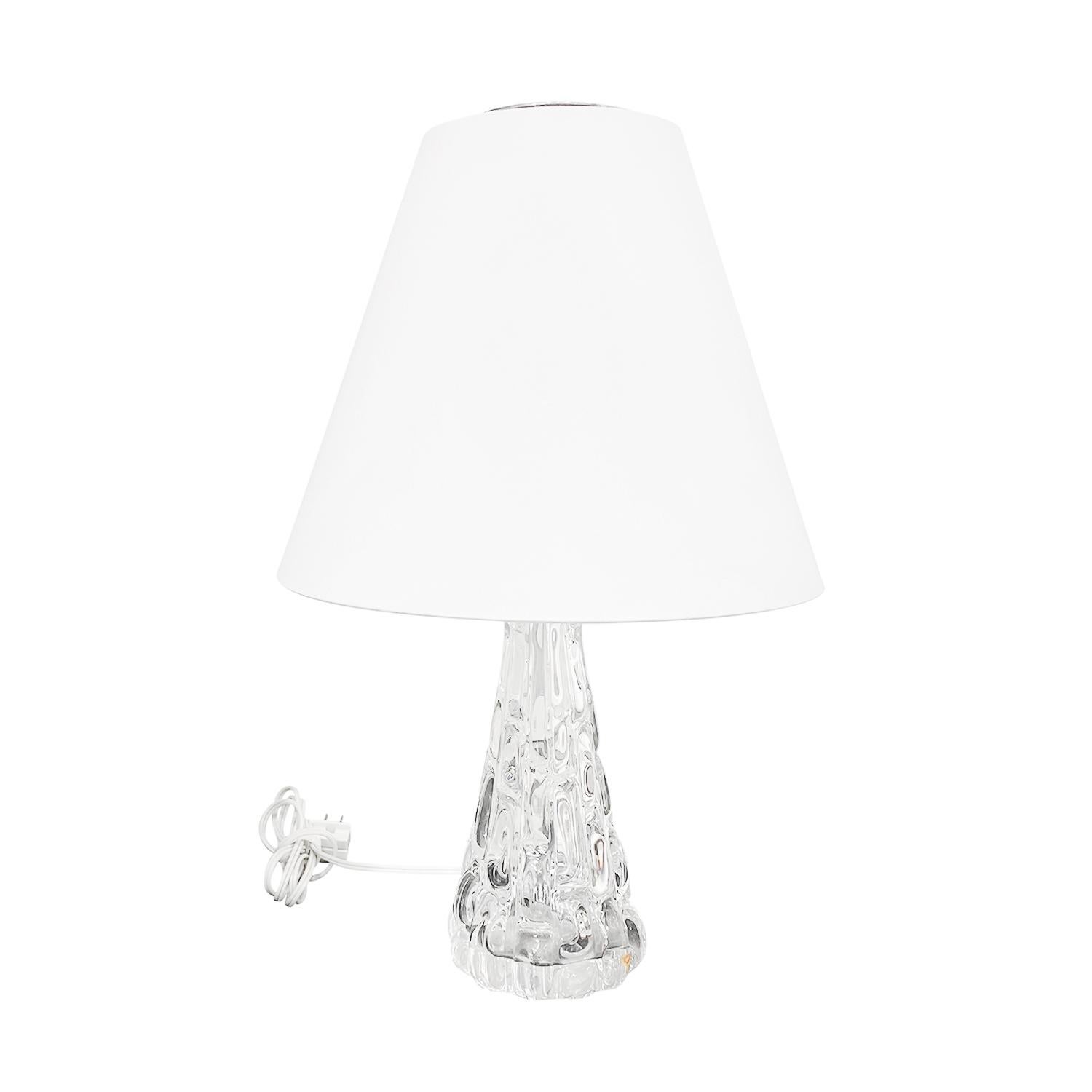 A vintage Mid-Century modern Swedish desk lamp with a new white round shade made of hand blown clear Orrefors glass, designed by Carl Fagerlund and produced, signed by Orrefors in good condition. The Scandinavian table light is enhanced with a