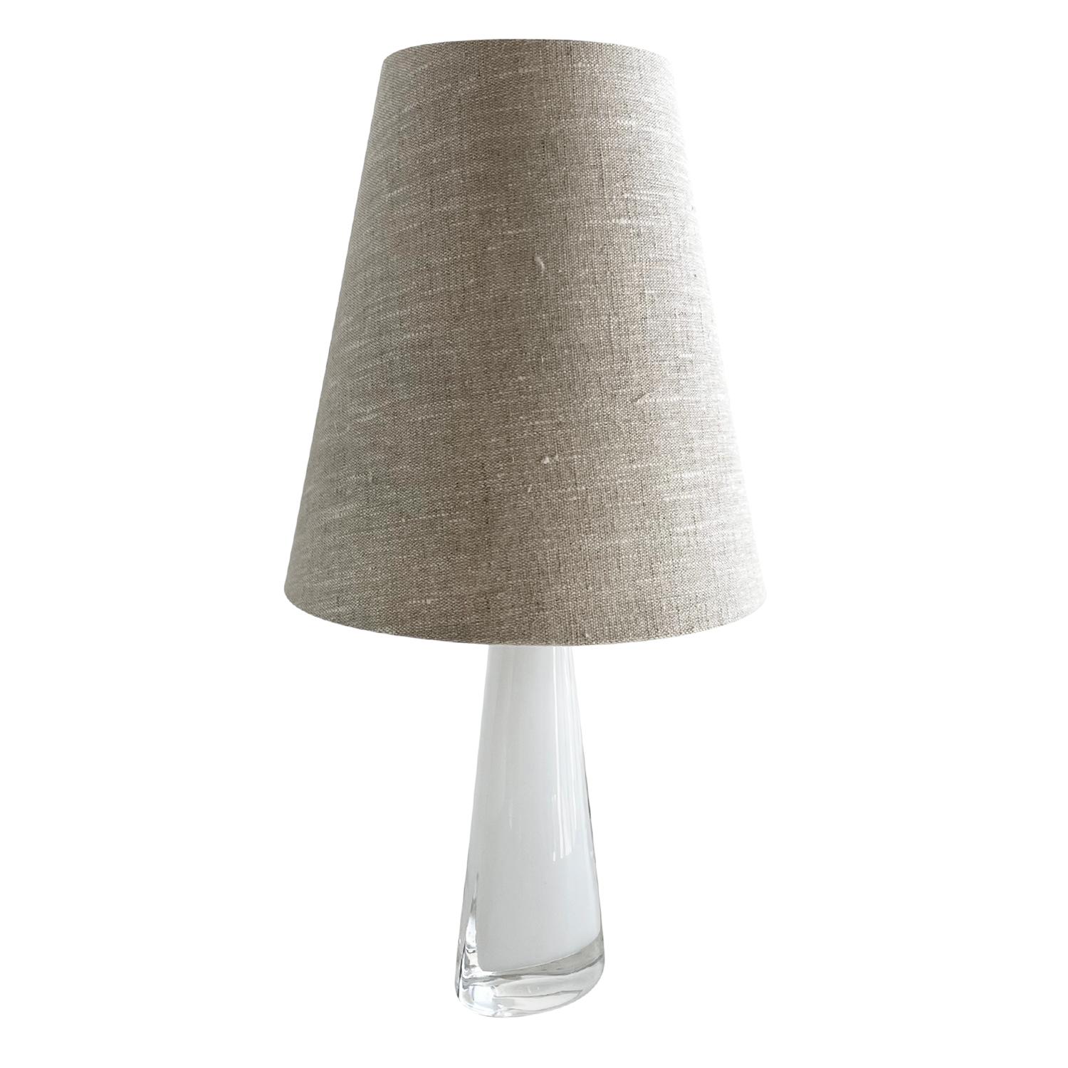 A small, vintage Mid-Century Modern Swedish table lamp made of hand blown smoked Orrefors glass, the beam is enhanced with a chrome ring, composed with a new light-grey shade, featuring a one light socket in good condition. The Scandinavian desk