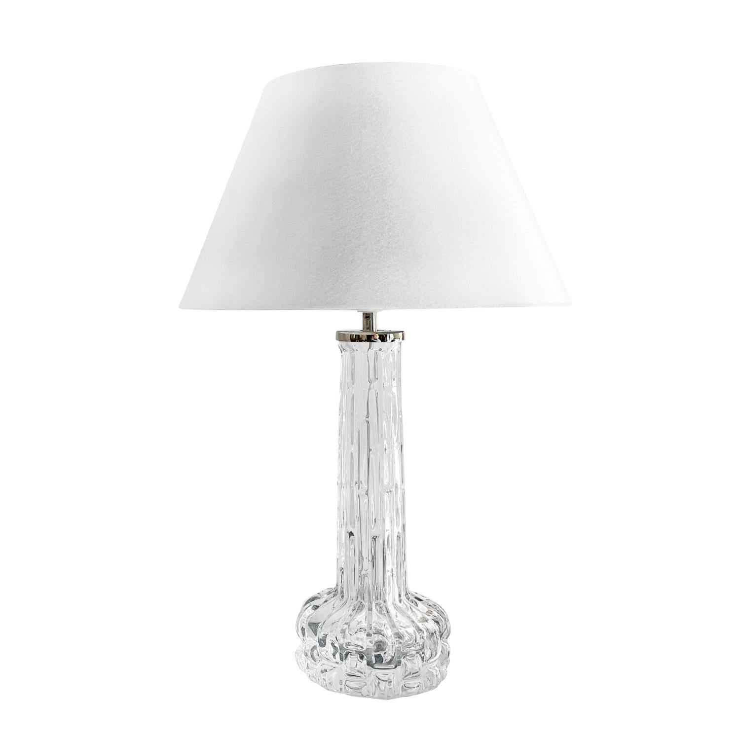 20th century Swedish Orrefors glass table lamp - desk light by Carl Fagerlund
PELI-1149
A vintage Mid-Century Modern Swedish table lamp made of hand blown Orrefors glass with a new white round shade, the beam is enhanced with a chrome ring,