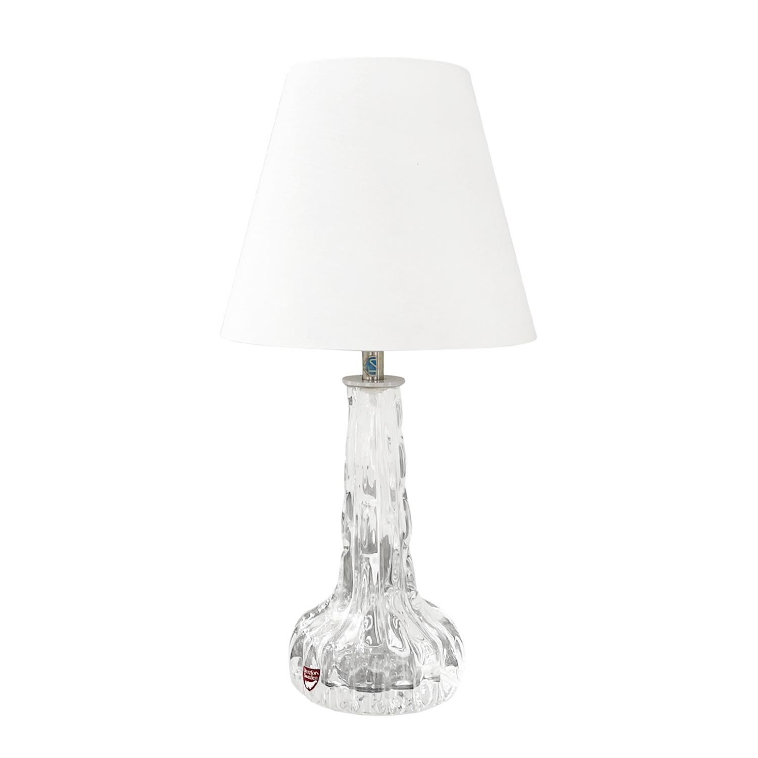 A vintage Mid-Century Modern Swedish office light with a new white round shade made of hand blown slightly smoked Orrefors glass, designed by Carl Fagerlund and produced by Orrefors in good condition. The Scandinavian table, desk lamp is consisting