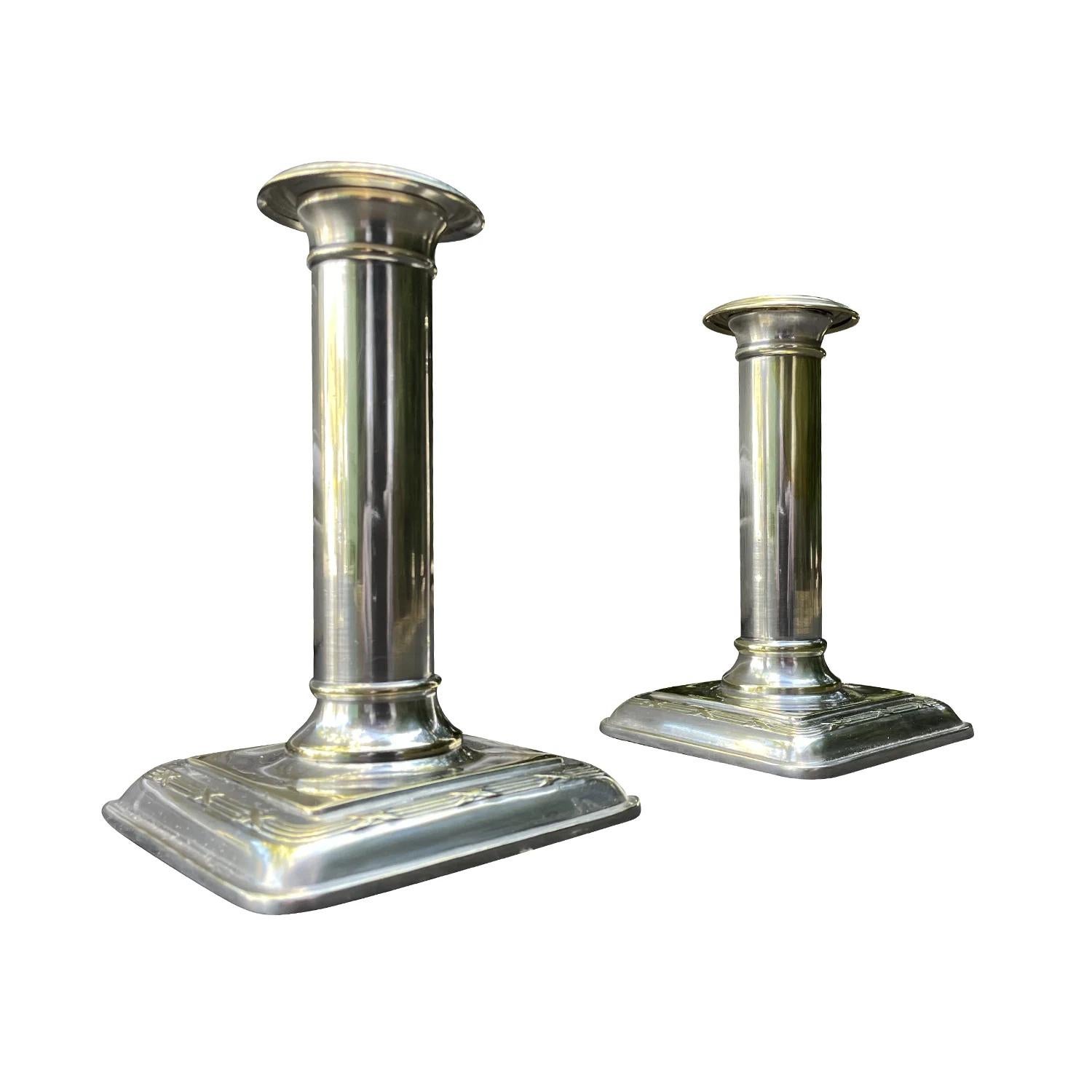 A vintage Art Deco Swedish pair of Ljusstake, candle holders made of hand crafted nickel silver, produced by C.G. Hallberg in good condition. The small Scandinavian candlesticks are enhanced by detailed hand crafting décor. Wear consistent with age