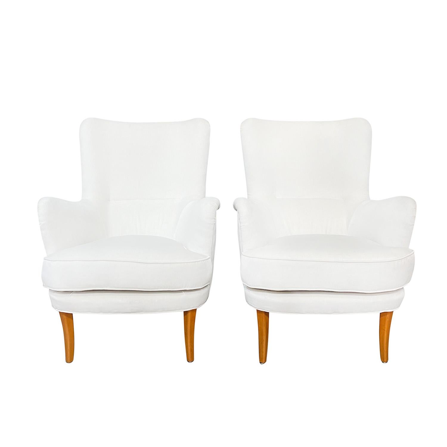 A 20th Century, vintage Mid-Century modern Swedish pair of Stora Furulid, club chairs made of hand crafted polished Beechwood, designed by Carl Malmsten and produced by Möbel Komponerad AV in good condition. The Scandinavian lounge, armchairs have
