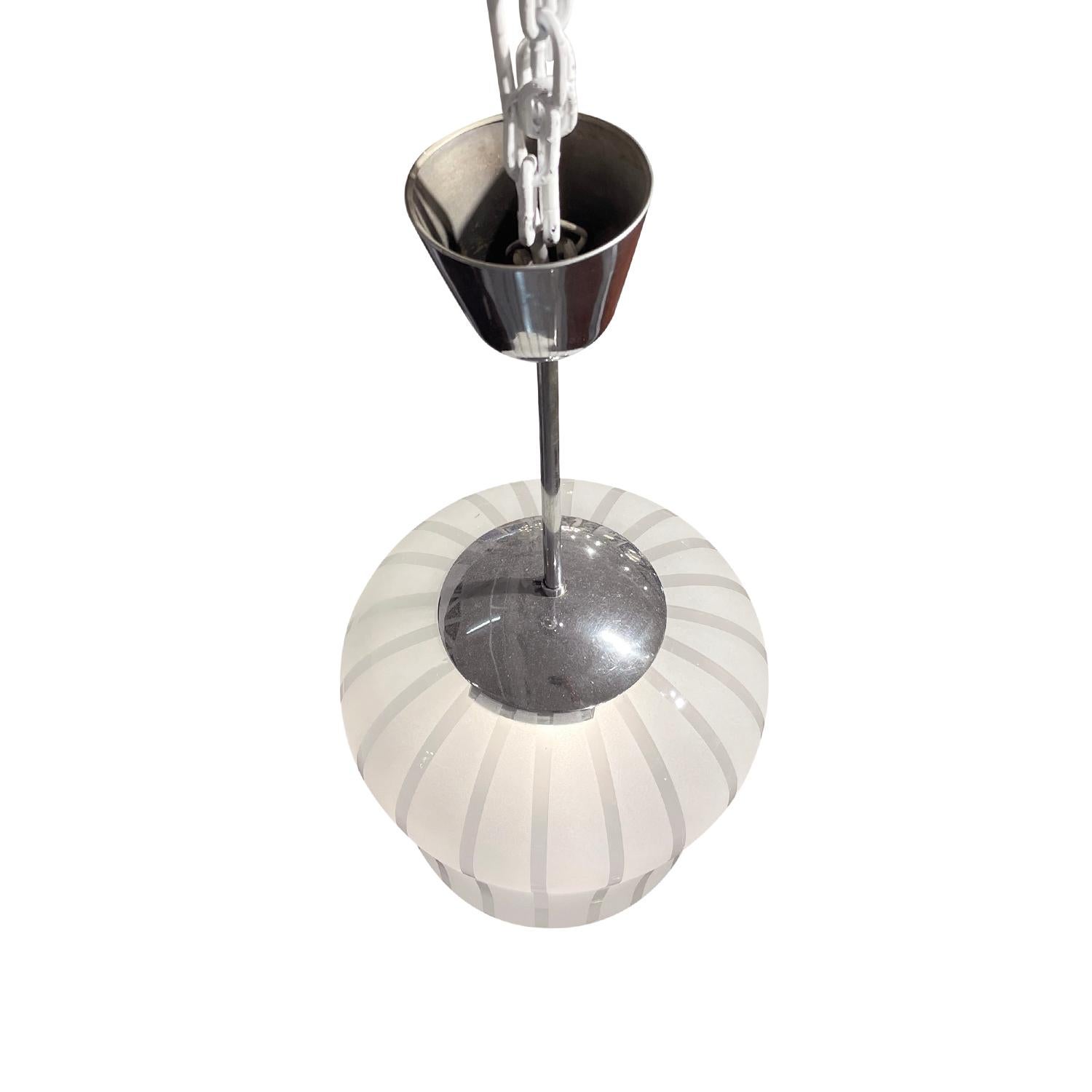 A half round, oval vintage Mid-Century Modern Swedish chandelier, pendant made of hand blown smoked Orrefors glass, the outside of the shade is polished with grey pattern, lines produced by Orrefors in good condition. The Scandinavian ceiling lamp,