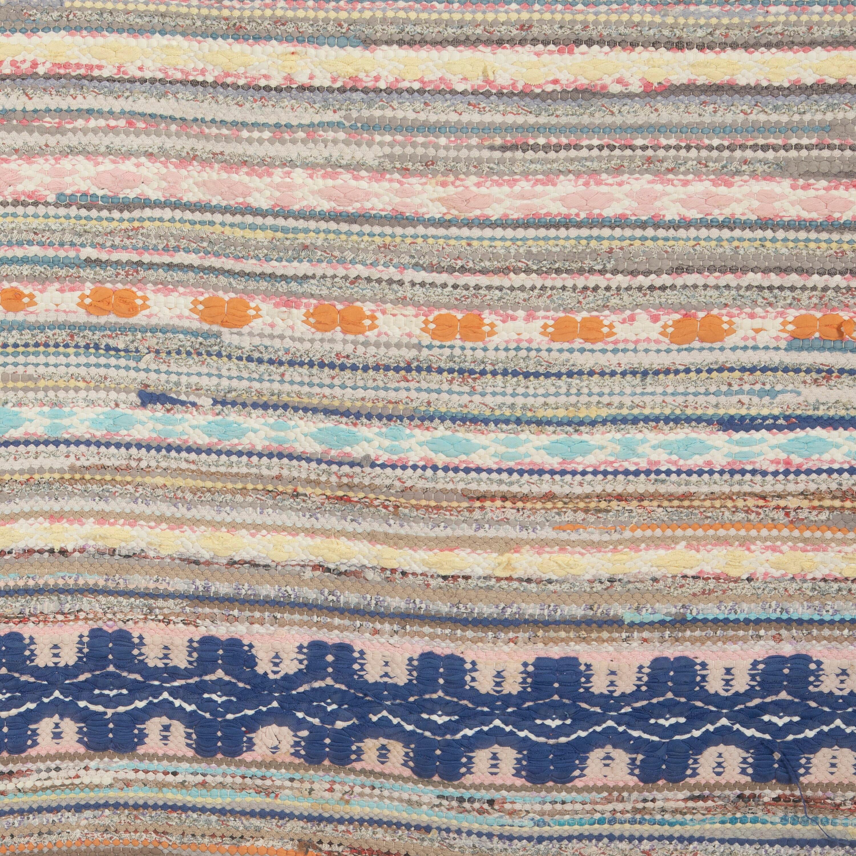 Traditional 20th century Swedish rag rug in tones of blue cream and rust,multi-pattern design. 
This rug has long proportions, ideal for use within a hallway or corridor. It features a dense pattern in a range of colours that have mellowed
