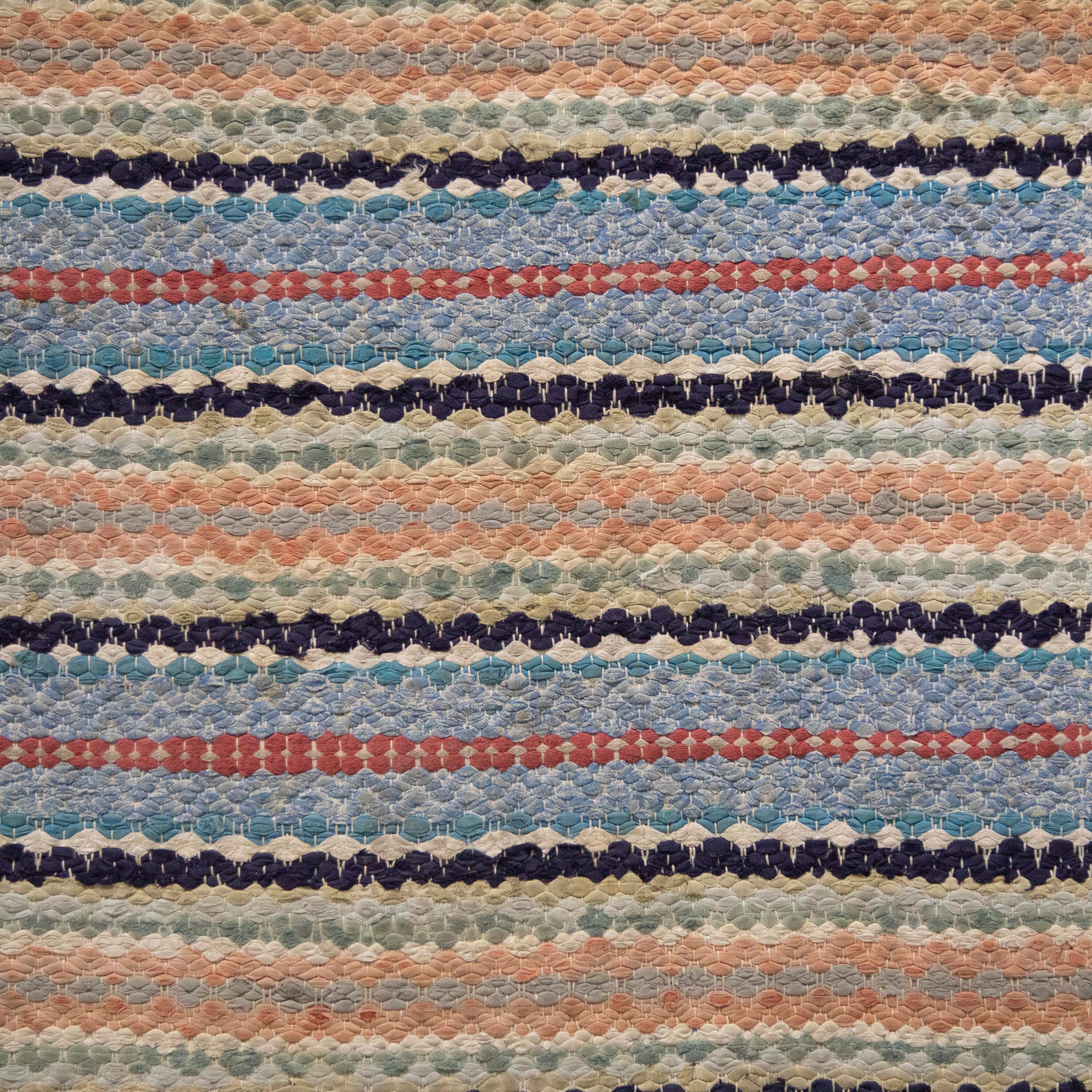 20th Century Swedish rag rug. Featuring a stripe design in muted tones of blue, black, red, and peach. This rug is machine washable at 30 degrees.
RT6024482.