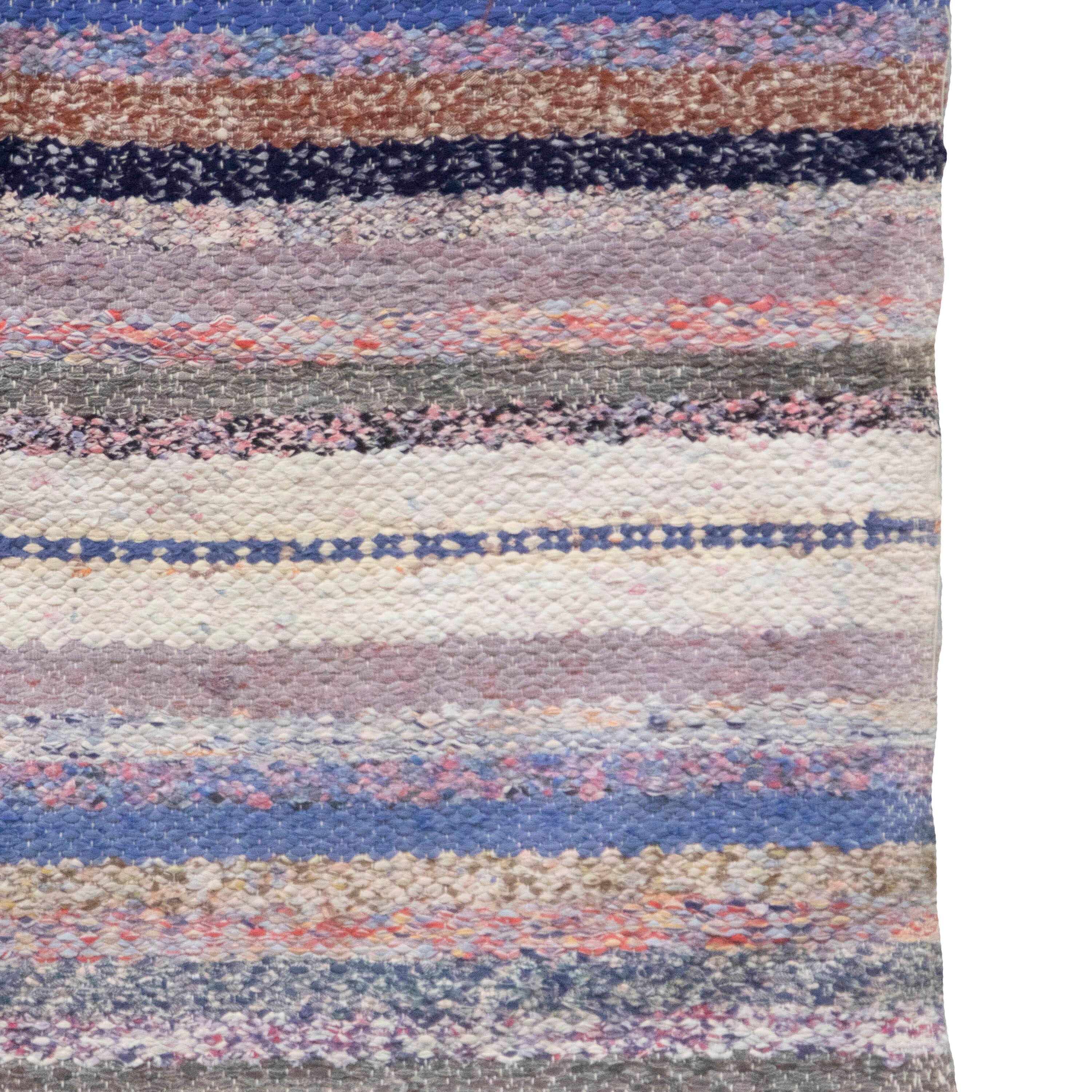 20th Century Swedish rag rug. Featuring a stripe design in tones of blue, black, brown, red, and grey. This rug is machine washable at 30 degrees.
RT6024598