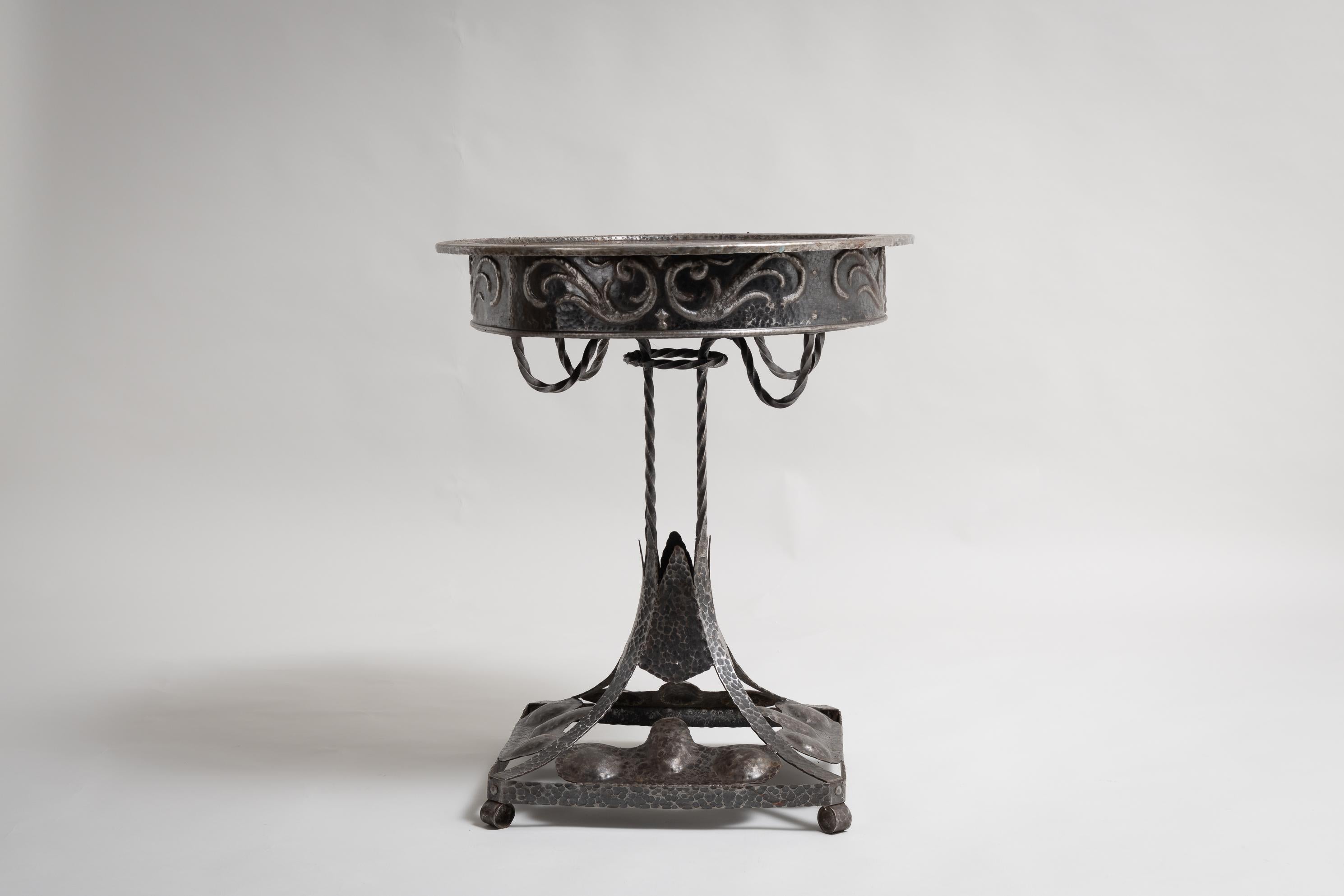 Swedish table in art nouveau style from circa 1920. The table is one of a kind and completely hand made from natural occurring iron. The table has marks from the hammer when the table was shaped which have become a part of the surface structure. Not