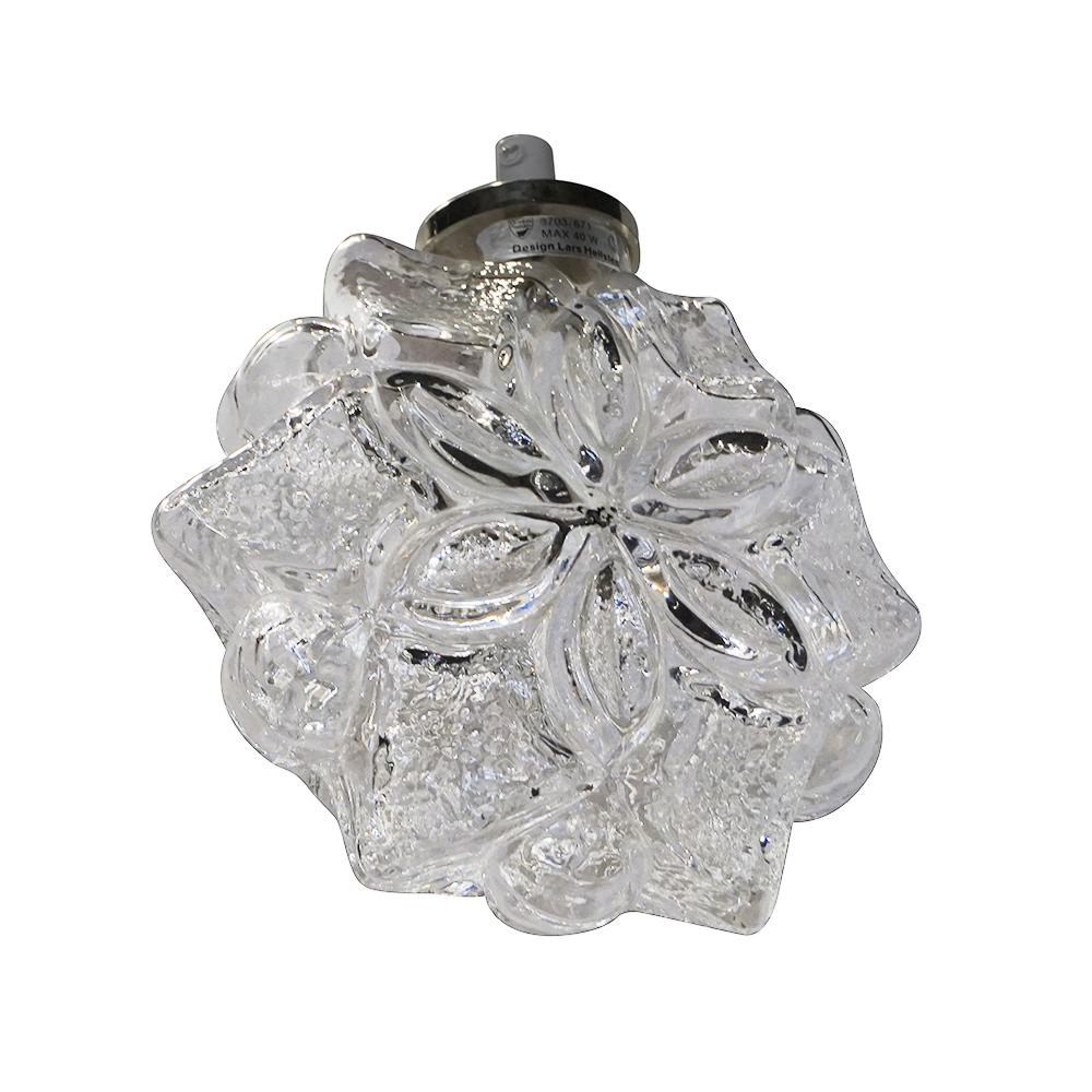 A vintage Mid-Century Modern Swedish hanging snowflake pendant, ceiling light made of hand blown Orrefors glass and chrome, produced by Orrefors, featuring a one light socket in good condition. Manufacturer label on the base. The wires have been