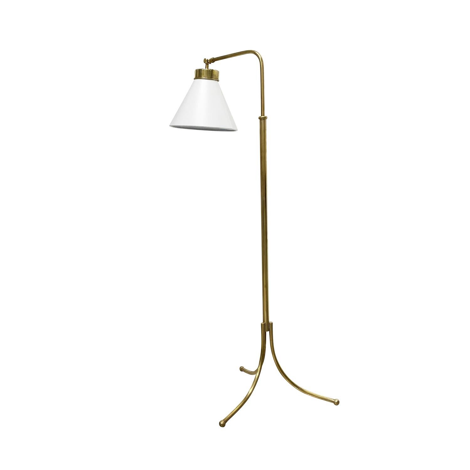 A vintage Mid-Century Modern Swedish floor lamp made of handcrafted polished brass, designed by Josef Frank and produced by Svenskt Tenn in good condition. The height of the Scandinavian light is adjustable, composed with a new white small round