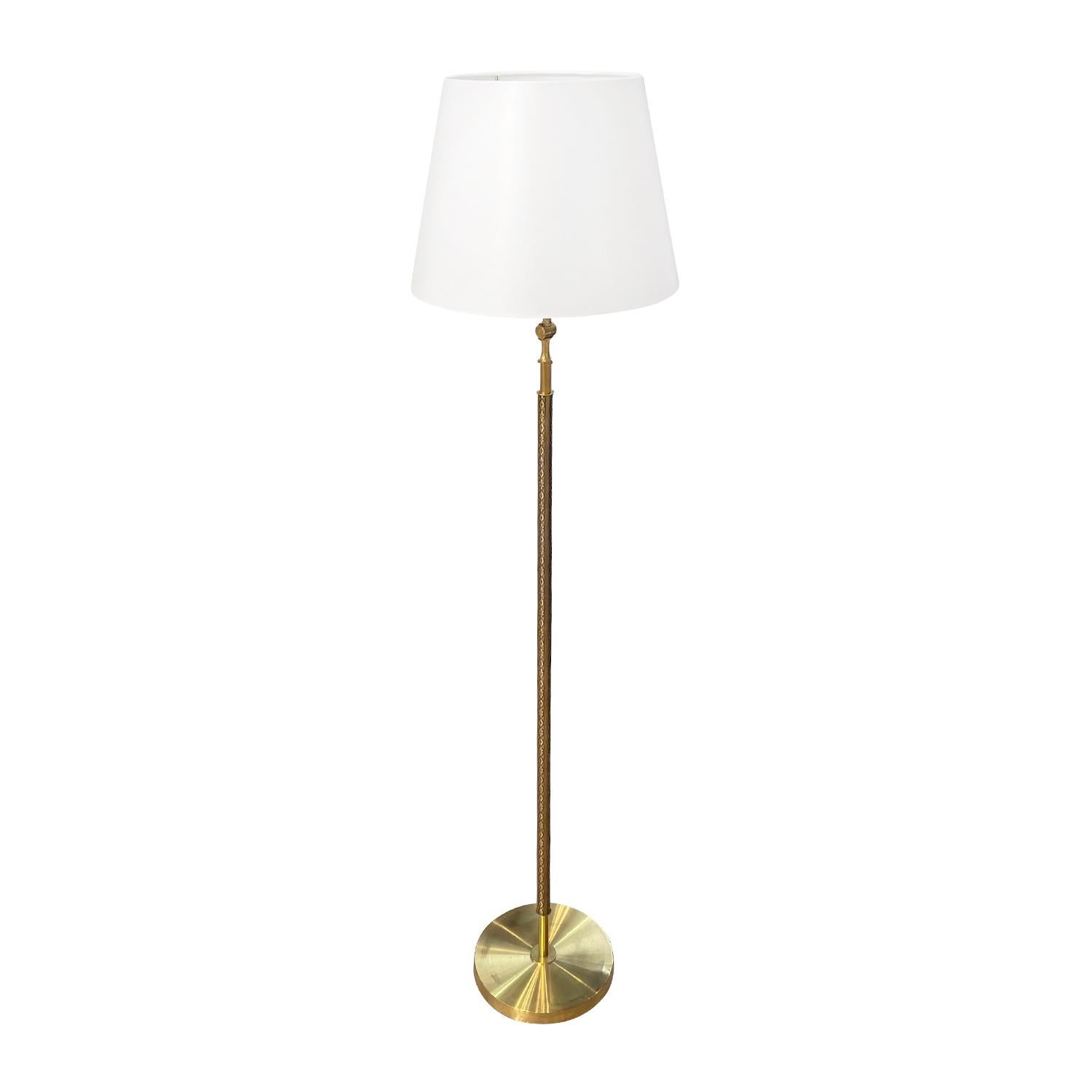 A vintage Mid-Century modern Swedish reading floor lamp with a new white round shade, made of hand crafted polished brass, designed by Falkenbergs Belysning in good condition. The stem of the Scandinavian light is enhanced by detailed brass flower