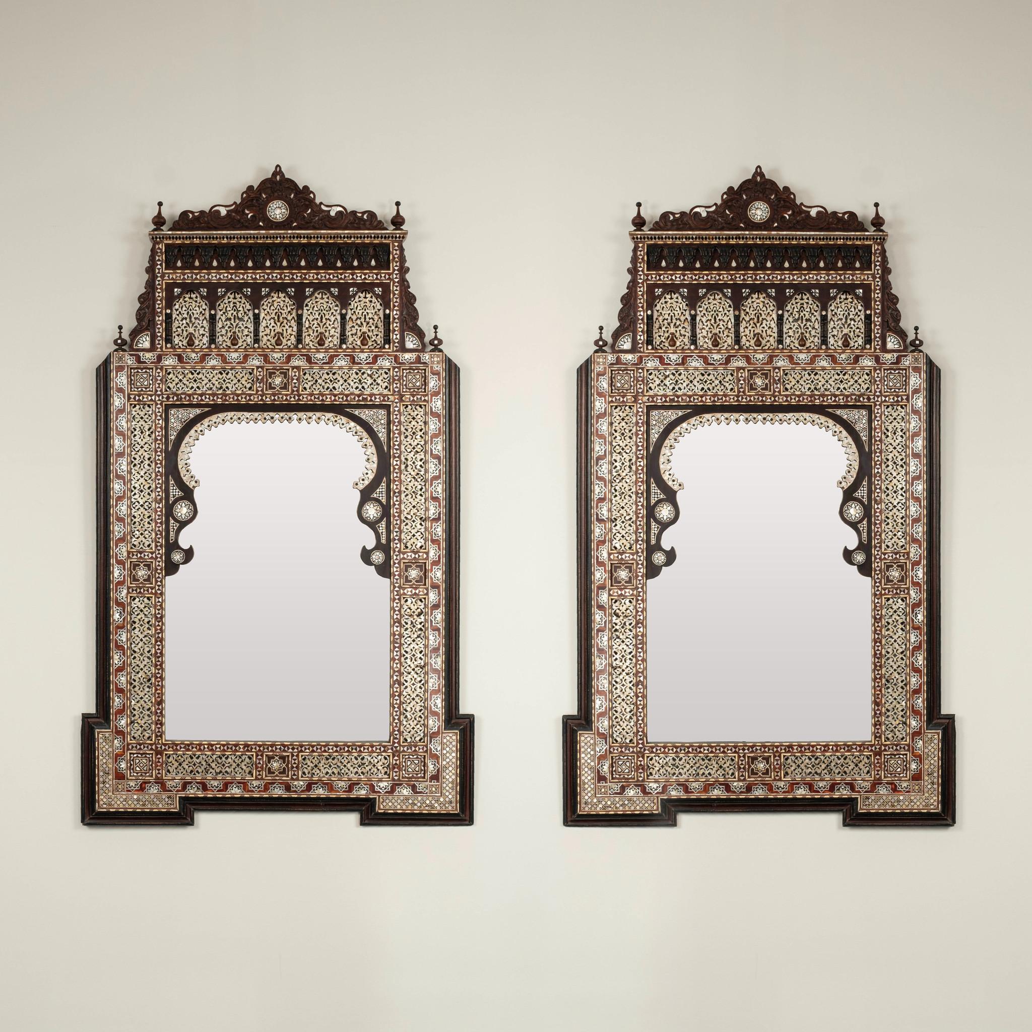 Lovely mid 20th Century Damascus mother-of-pearl and bone inlay wood mirrors. These wonderful Múdejar design mirrors feature beautiful detailed abstract geometry, horseshoe with multifoil arches. and finials.

Two available, sold individually at