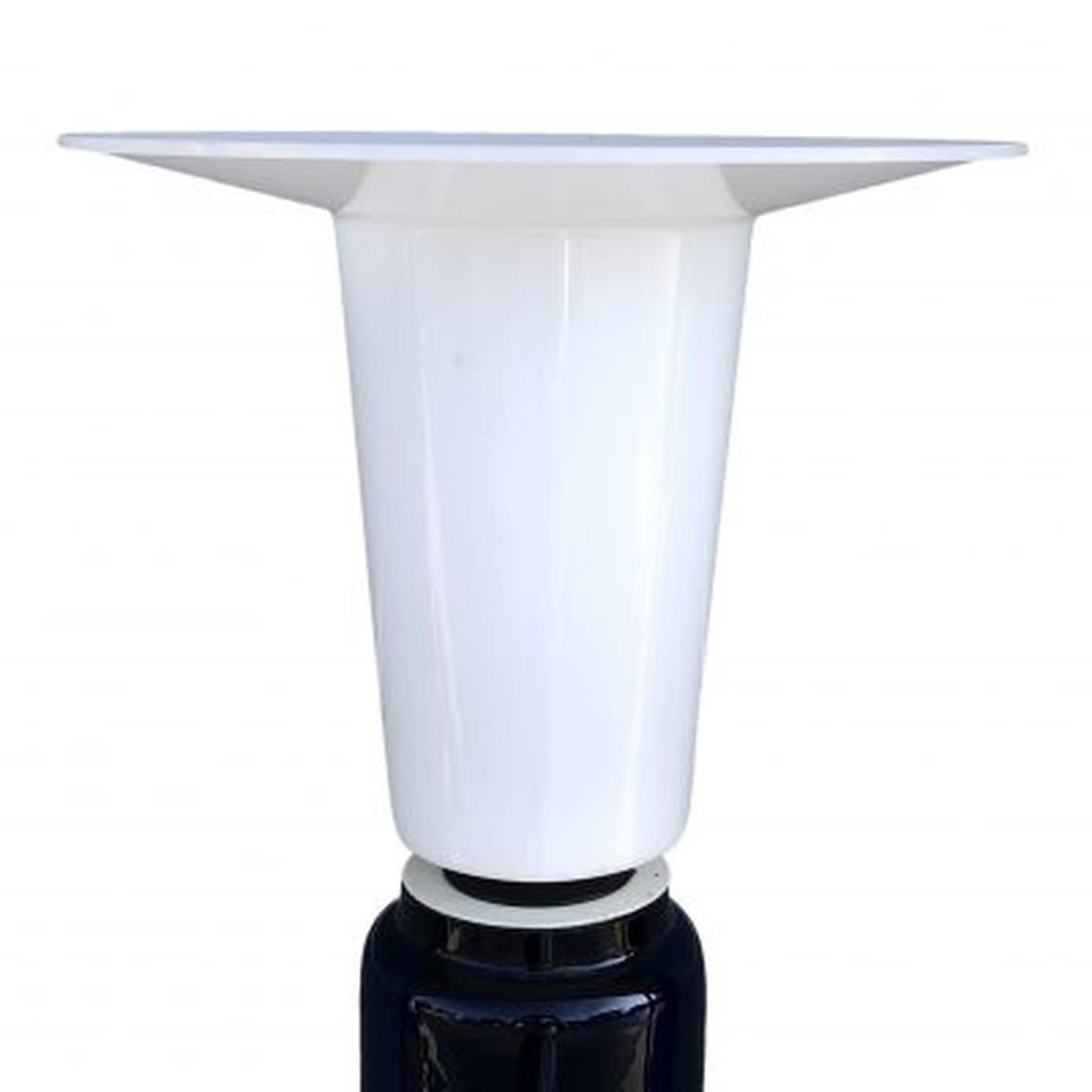 A blue, vintage Mid-Century modern Swedish table lamp made of a round, hand blown glass base with a white acrylic, plastic shade, featuring a one light socket. The Scandinavian desk light was designed by Uno & Oesten Kristiansson and produced by