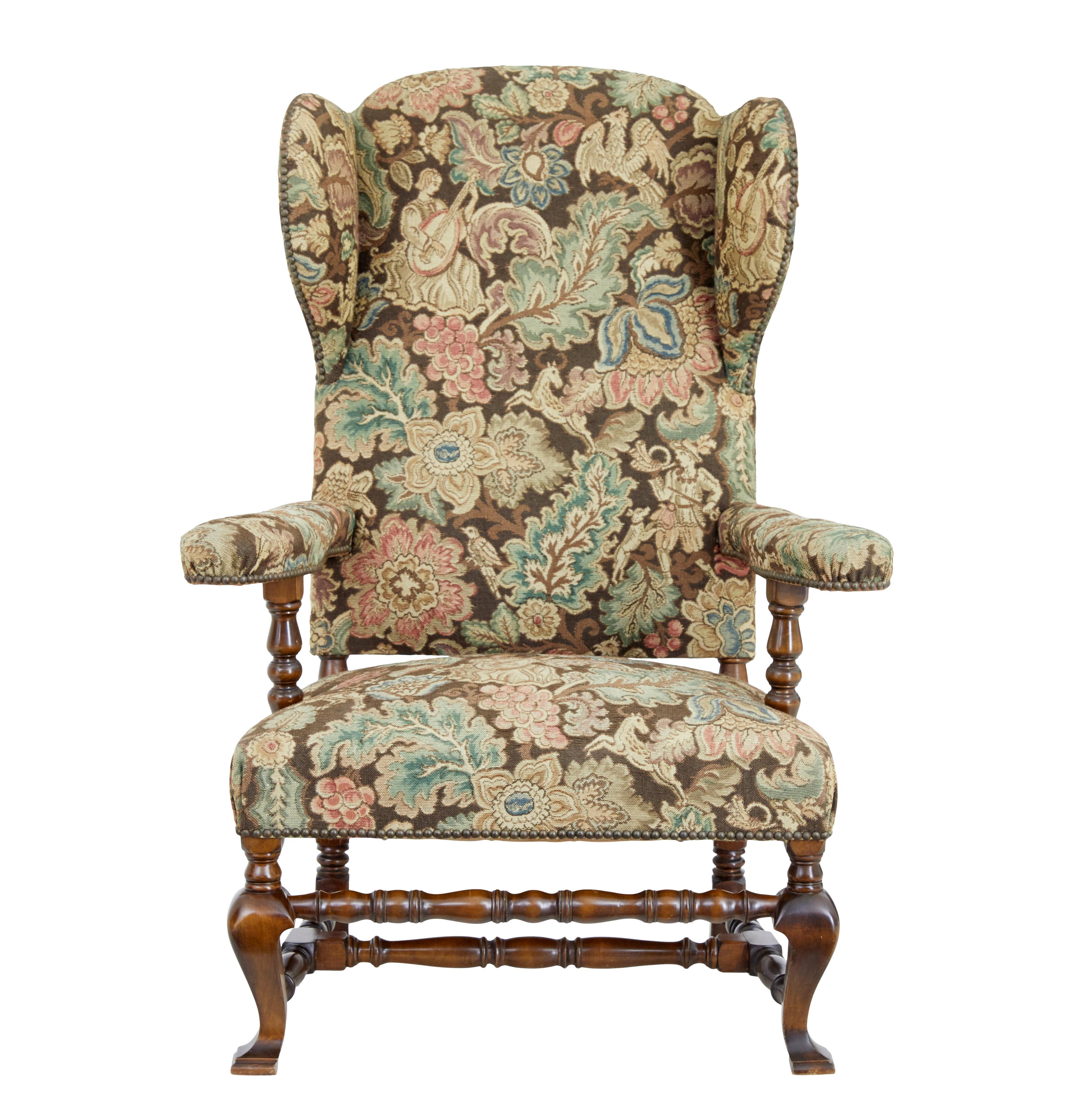 Early 20th century stained beech wingback armchair, circa 1920.

Here we have a fine tapestry covered very comfortable wingback armchair. Upholstered in a superb quality floral tapestry with mythical beasts. Shaped arms with well padded back