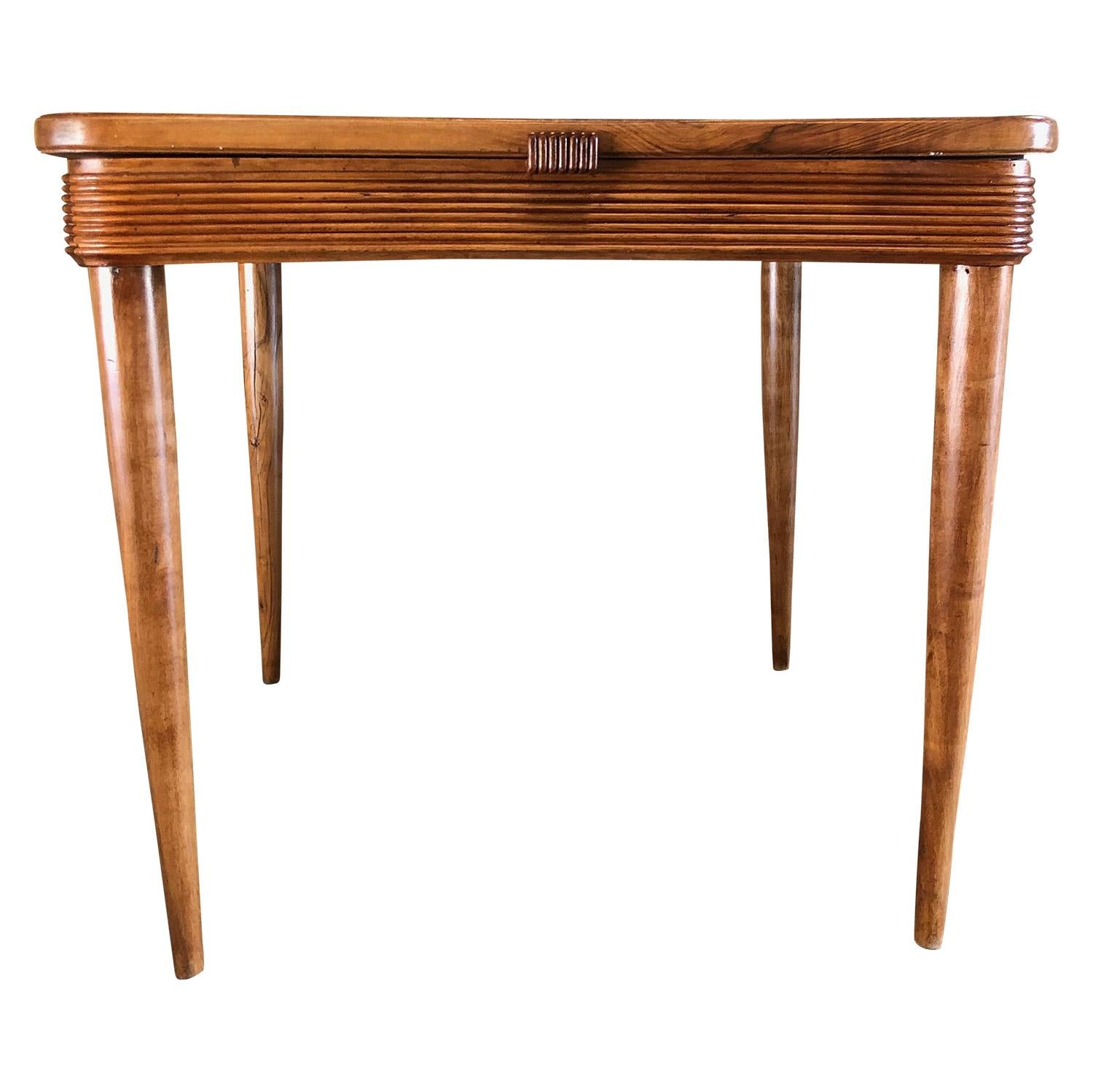 A rare Mid-Century Modern Tavolo da Pranzo, a small Italian dining table or kitchen table with rounded corners in a grissinata finish, the table surface is portable, composed with a storage compartment. The table is made of wood standing on four