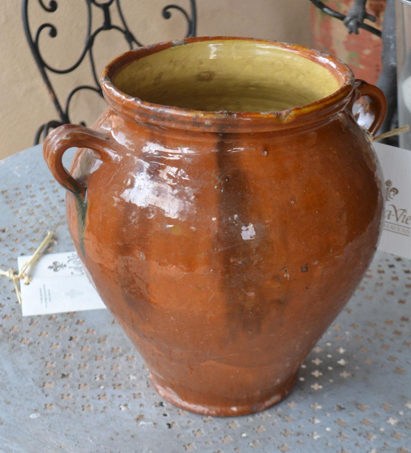 Turn of the century terra cotta pot with brown glaze, top and bottom rim glaze chipping.Once a common piece of pottery used daily in French kitchens, these earthenware jugs have become showcase pieces sought by designers and collectors. These