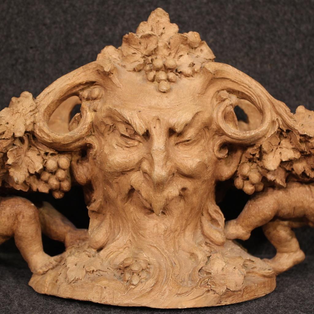 French centerpiece from the first half of the 20th century. Finely chiseled terracotta object with masks (faces with different expressions, see photo) and figures of lateral cherubs of excellent quality. Sculpture signed on the base G. Flamand (see