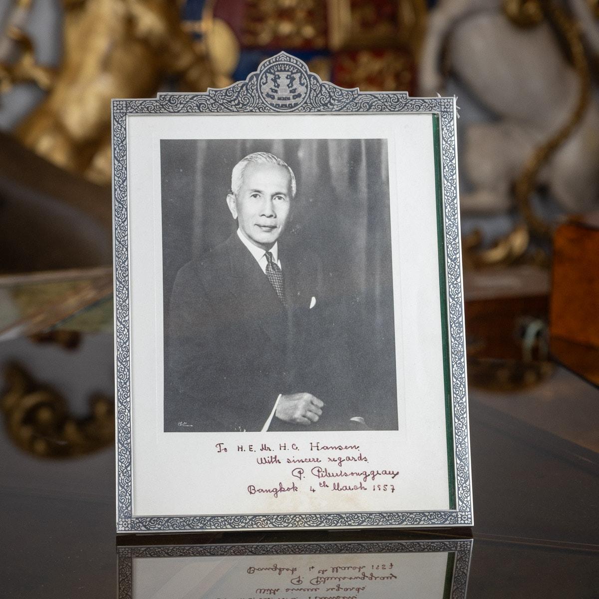 Stunning mid-20th Century Thai very large solid silver & niello presentation photograph frame. Upright rectangular form with shaped top, inside bearing the photograph of Field Marshal Plaek Phibunsongkhram, frame boarders decorated with dense floral