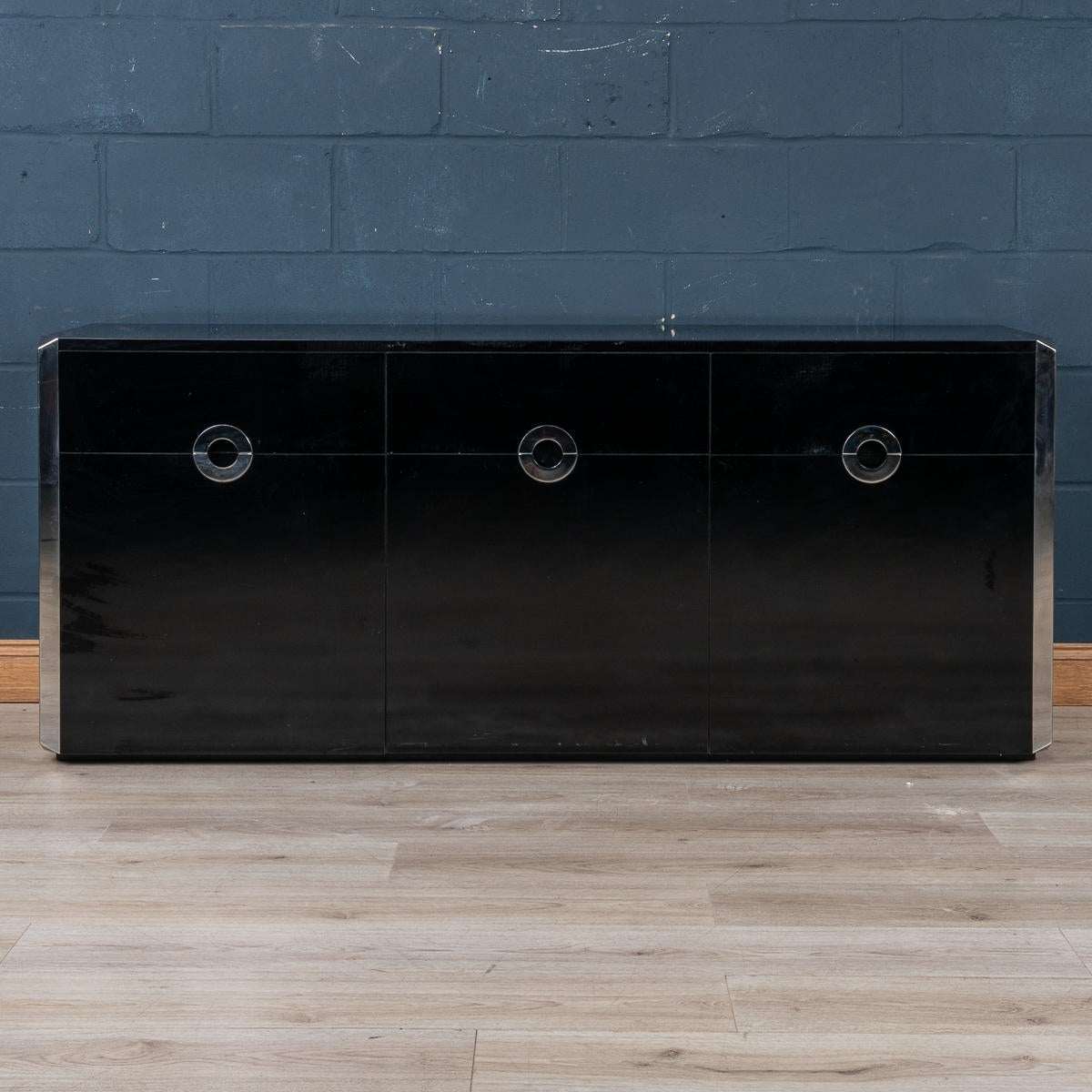 An elegant three-door sideboard designed by Willy Rizzo for Mario Sabot, produced in Italy in the 1970s. The gloss finish laminate veneer is beautifully accentuated by mirror polished stainless steel handles and edging. The two doors open 180