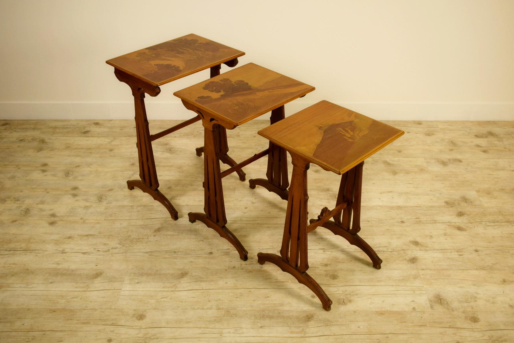 20th century, three French nesting wood coffee tables by Emile Gallè (1846-1904) 
signed on each tray with very pretty Japanese-style signatures.

Sizes:
large coffee table: W cm 50, D cm 39, H cm 69
medium coffee tables: W cm 44, D cm 38, H cm