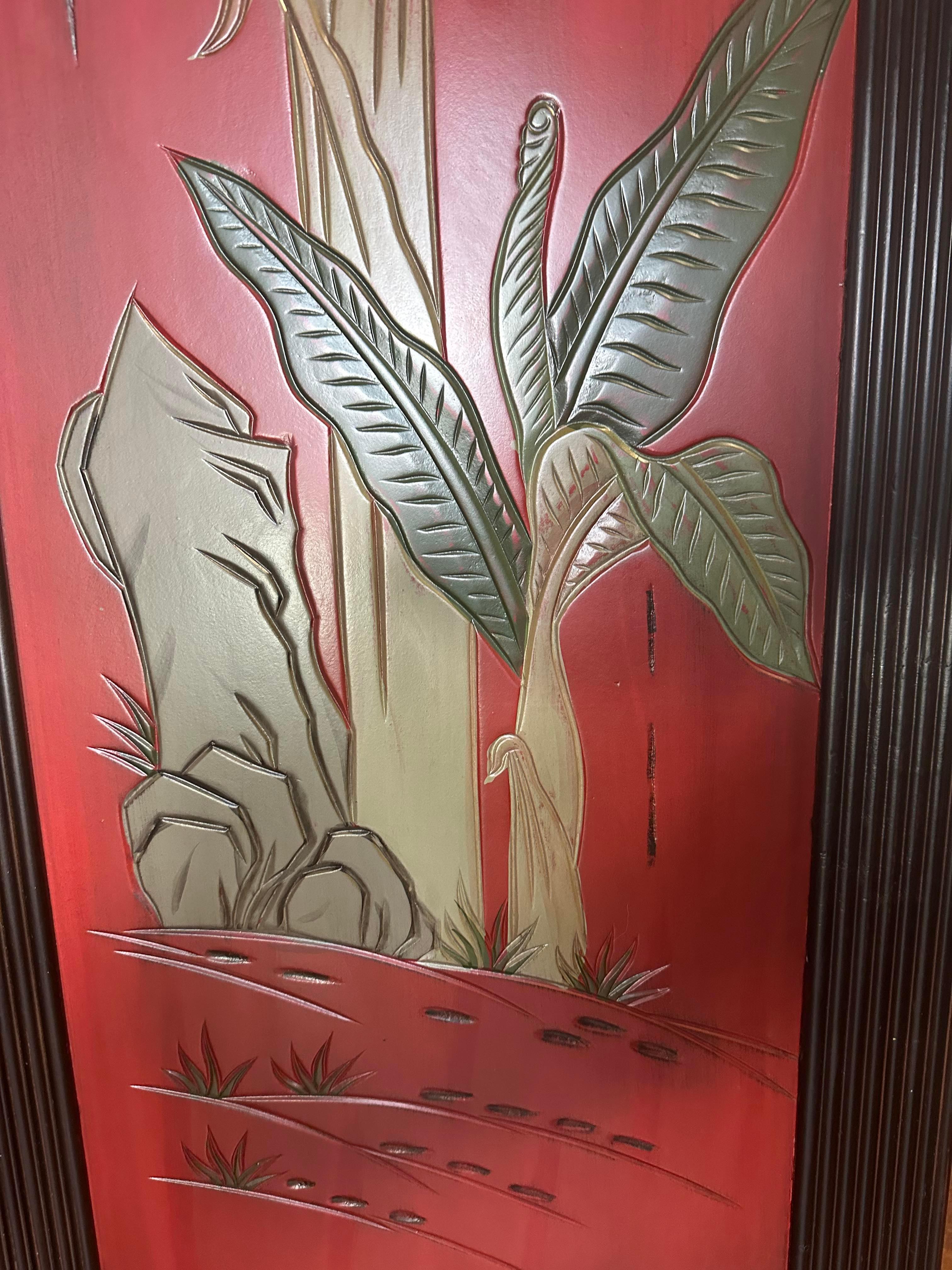 20th century Asian three-panel screen or room
divider in red with palm leaf decoration. 
Striking crimson red will accent any room.
Good vintage condition with age appropriate wear.
Solid, hand carved and hand painted wood. 
Each panel is framed.