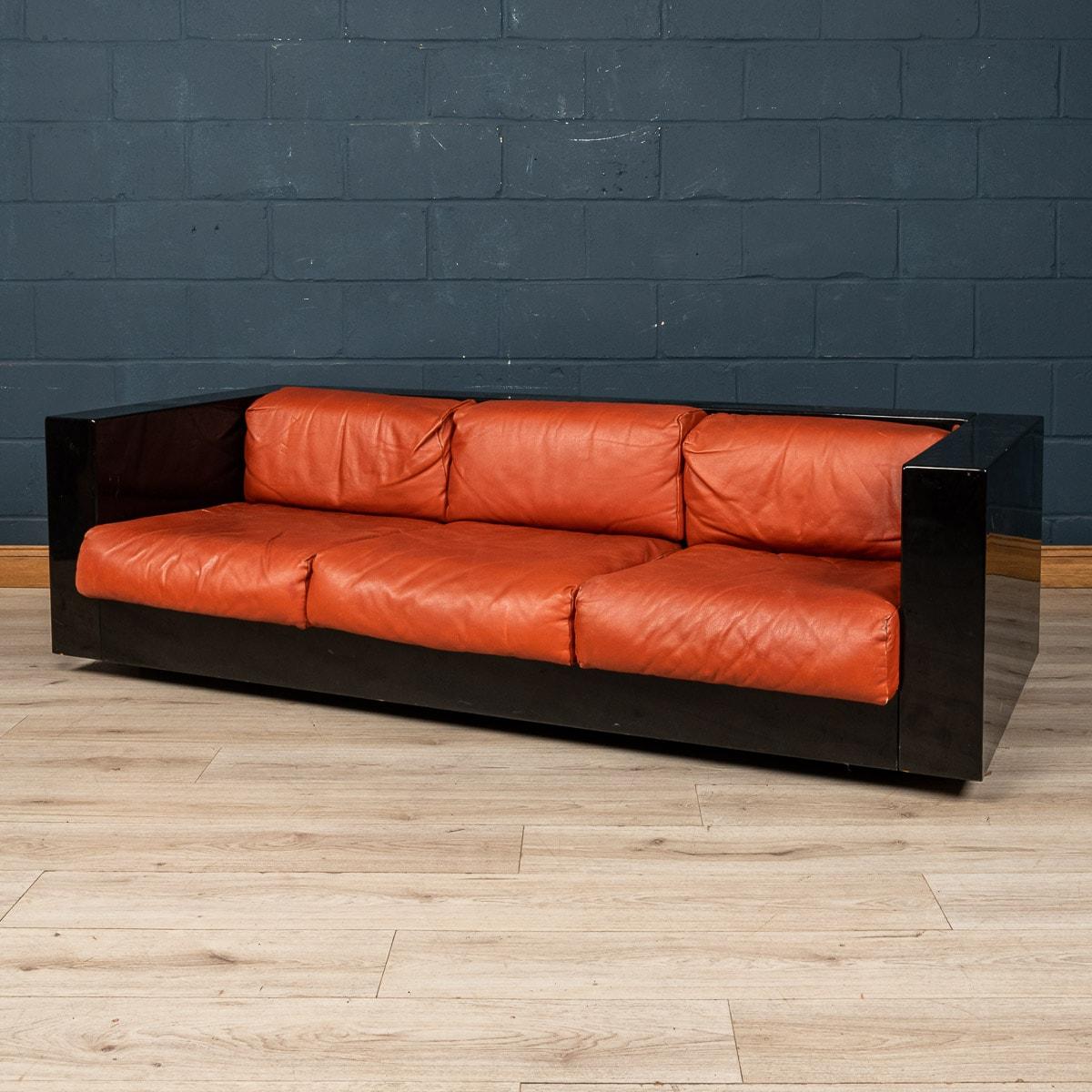 A lovely three seater sofa designed by the Italian designer couple Lella and Massimo Vignelli. Produced by Poltronova of Florence, the sofa is a design classic with a wonderful black and red combination for the frame and cushions respectively.
