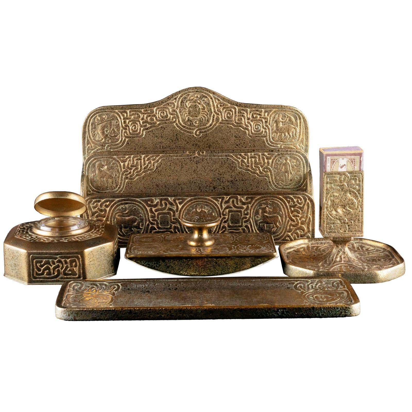 An extraordinarily well kept 6 piece set of the beautiful Zodiac Desk Set made by Tiffany Studios in the late 19th and early 20th century. It captures the aesthetic zeitgeist of the period perfectly in it's Art Nouveau low relief design in bronze
