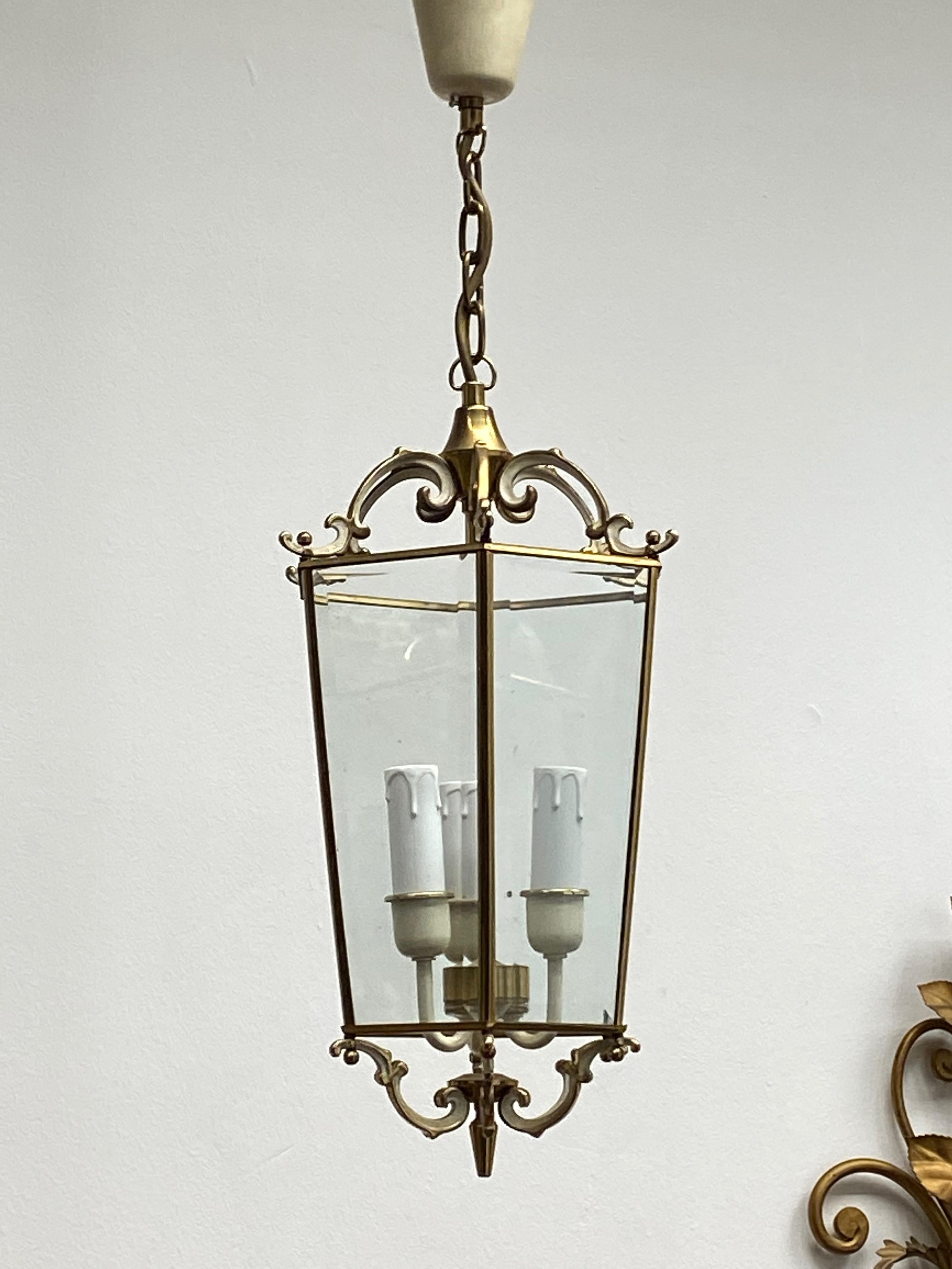 Add a touch of opulence to your home with this charming lantern pendant light. Perfect gilt and white lacquered metal to enhance any chic or eclectic home. We'd love to see it hanging in an entryway as a charming welcome home. Built in the 1960s, in