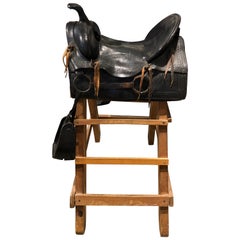 20th Century Tooled Leather Saddle and Rustic Wood Stand