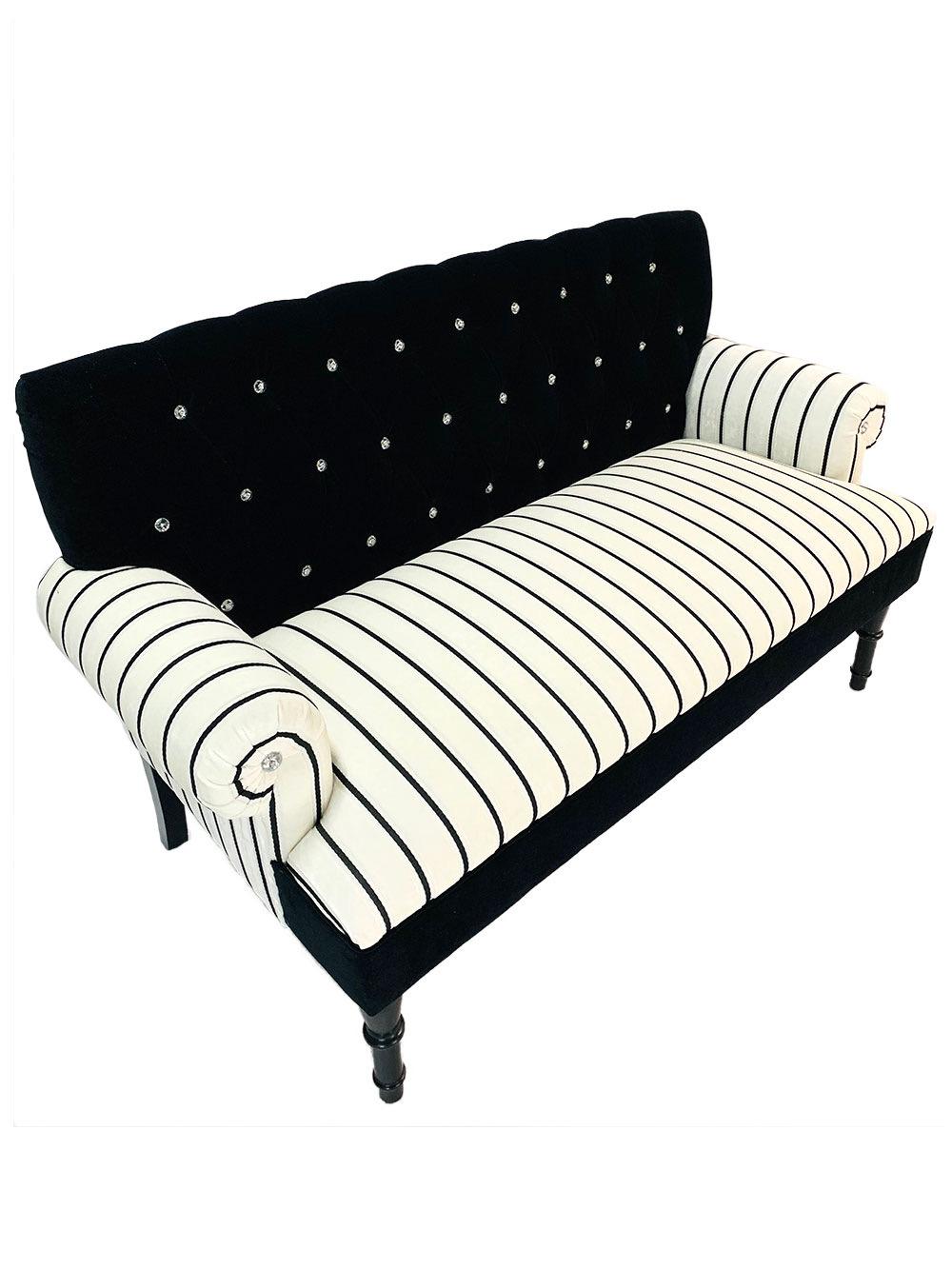 20th century traditional Chesterfield style settee with rolled arms and crystal button tufts on a black velvet back contrasted with elegant Stroheim black satin and white cut velvet stripe fabric.