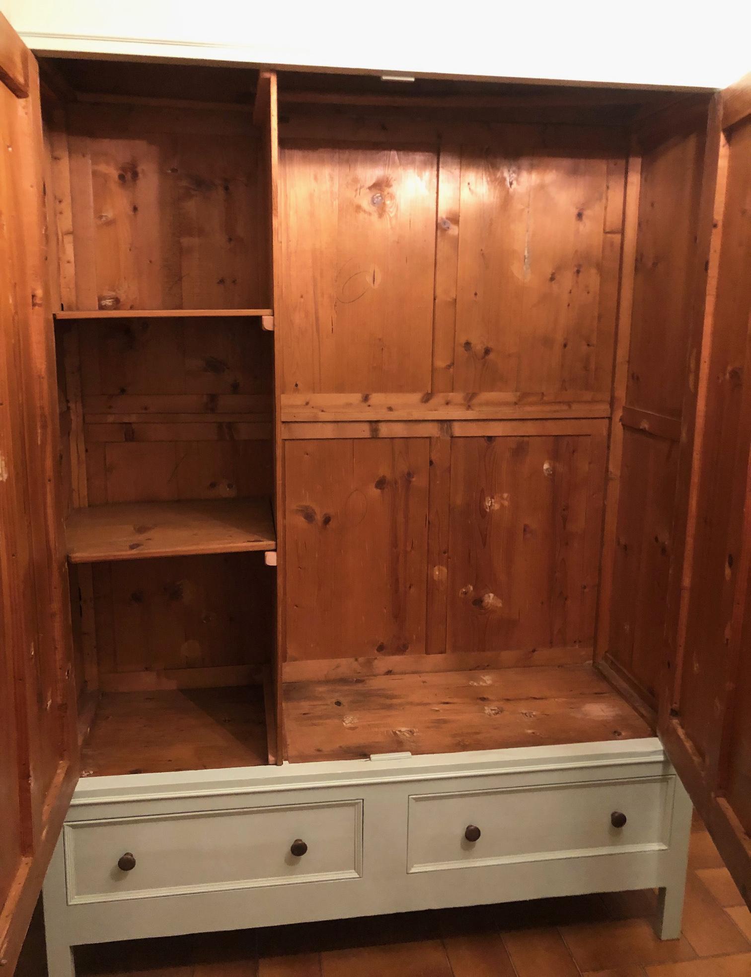 20th Century Tuscan light green two-door wardrobe with drawers.
The wardrobe is made of solid fir wood, completely dismantled into approximately 15 elements.
It is very robust and versatile.
It has two internal shelves on the left side and a clothes