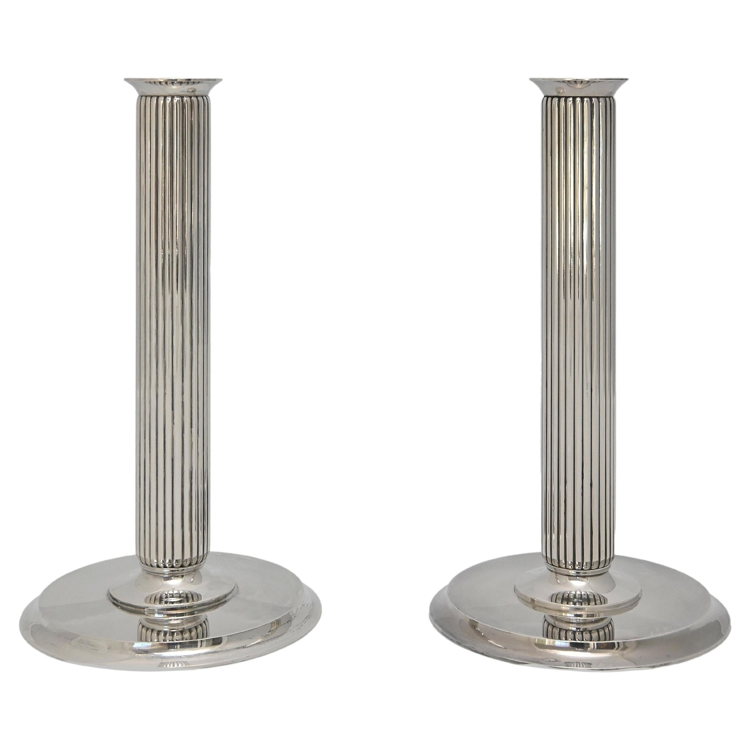 Two Pairs  of candlesticks 855 E by Georg Jensen Denmark , design Prince Sigvard Bernadotte  
The straight design and particular style, without any other decorations than the lines of the ribs shows Sigvard Bernadotte as one of the first modern