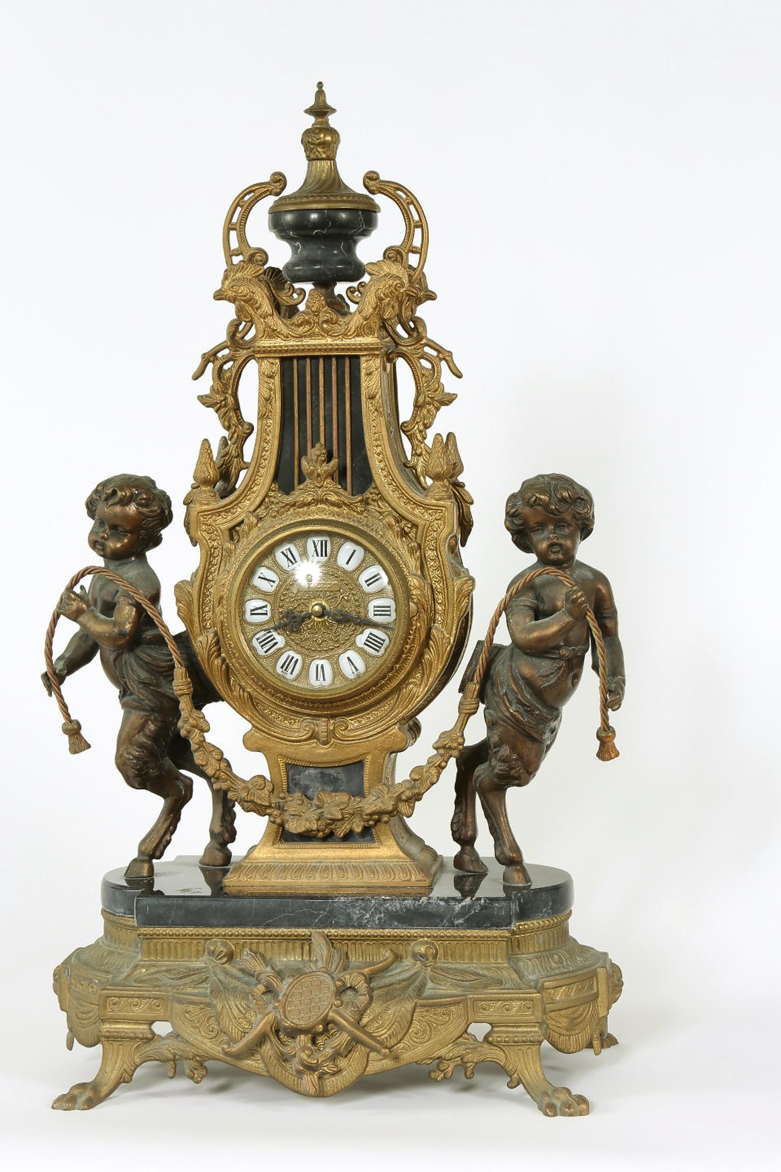 Two tone bronze three piece garniture set. Footed marble base clock with two six arm candelabras. The clock stand about 24.5 inches H x 14 inches L x 8.5 inches W. Good vintage condition. Minor wear and oxidation to metal. Missing pendulum. Each