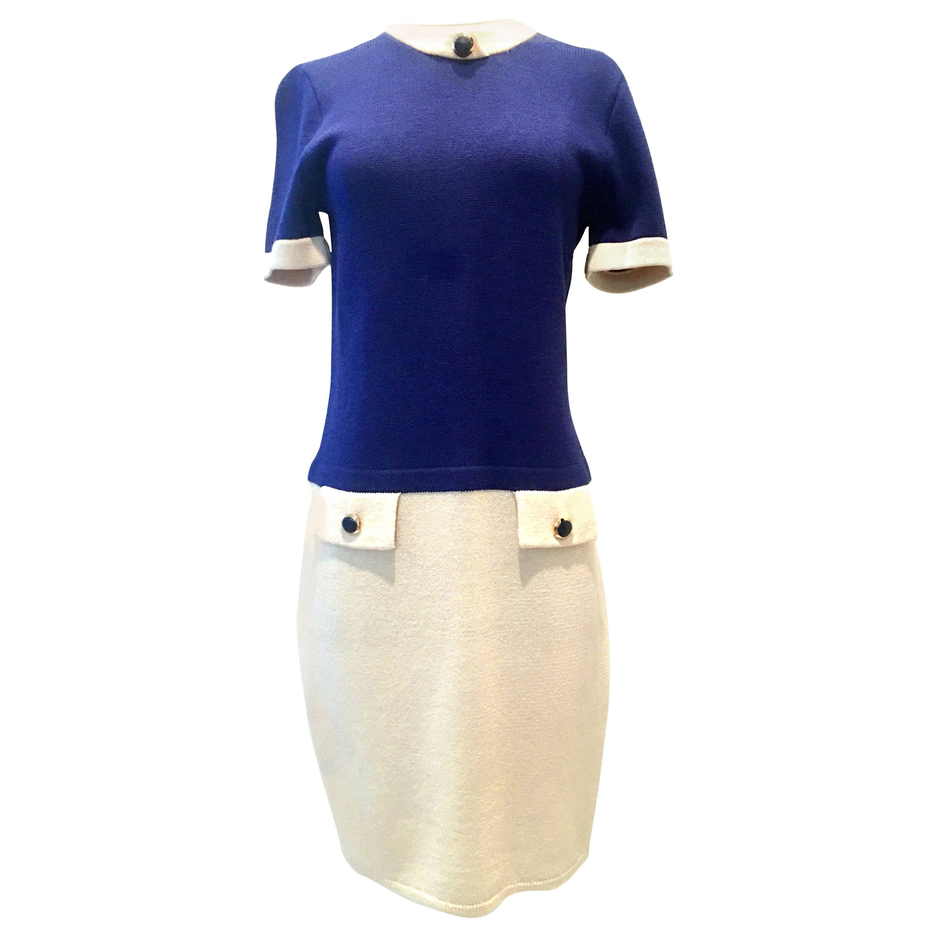 20th Century St. John Knit Two Tone Short Sleeve Dress By, Marie Gray-Size 4. This pristine
cream and royal blue bateau style short sleeve dress features big bold gold and navy button detail with front asymmetrical front faux pockets. There is a