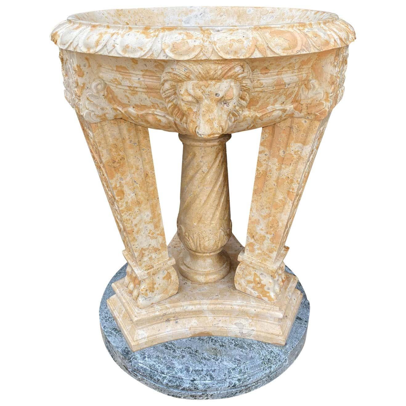 A stunning 20th century two toned marble planter/Tazzer/bird bath. The frieze is decorated with lion masks and lion paw feet, standing on a Verdi Antico marble base, and a central twisted column. Ideal for exterior use.