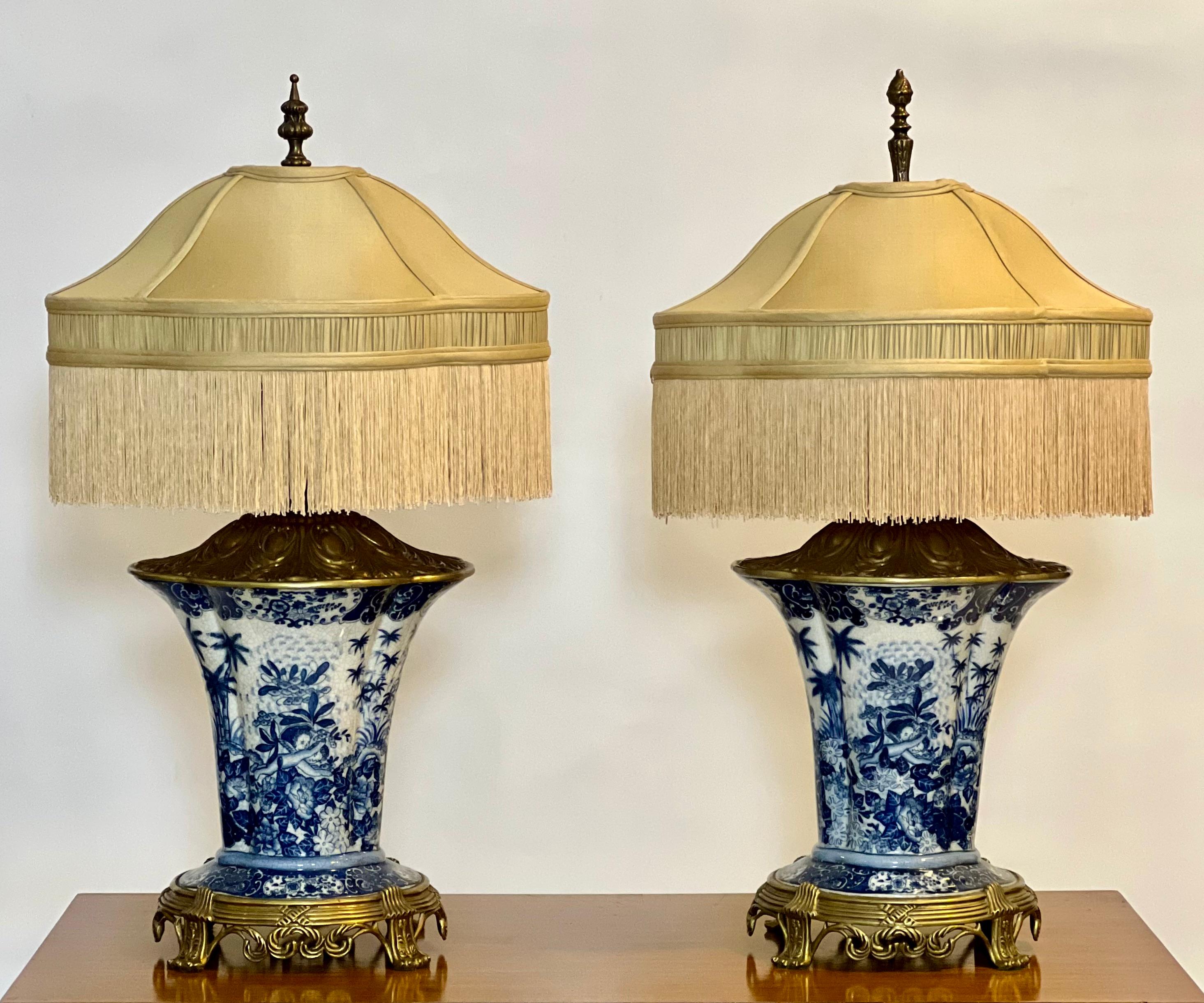 Pair of late 20th century ormolu and crackle porcelain lamps by United Wilson Porcelain, signed.

Stunning blue and white vase form lamps with ornate ormolu mounts. Part of United Wilson's ormolu series inspired by 18th century French antiques, the