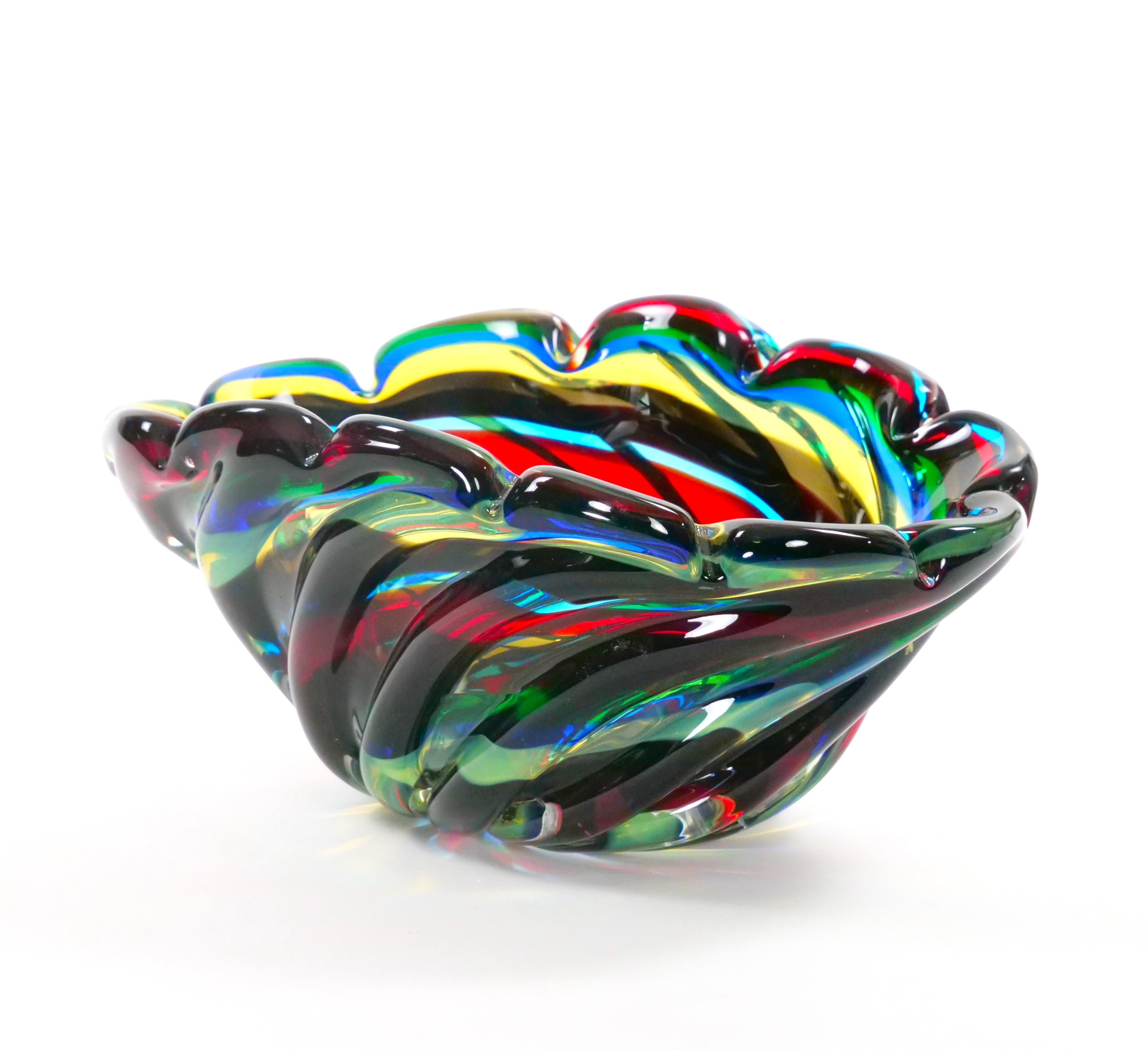Elevate your decor with the vibrant allure of this late 20th-century Venetian multicolored glass decorative centerpiece bowl, crafted in Venice, Italy around 1975. Skillfully mouth-blown and handcrafted, this exquisite bowl showcases the artistry