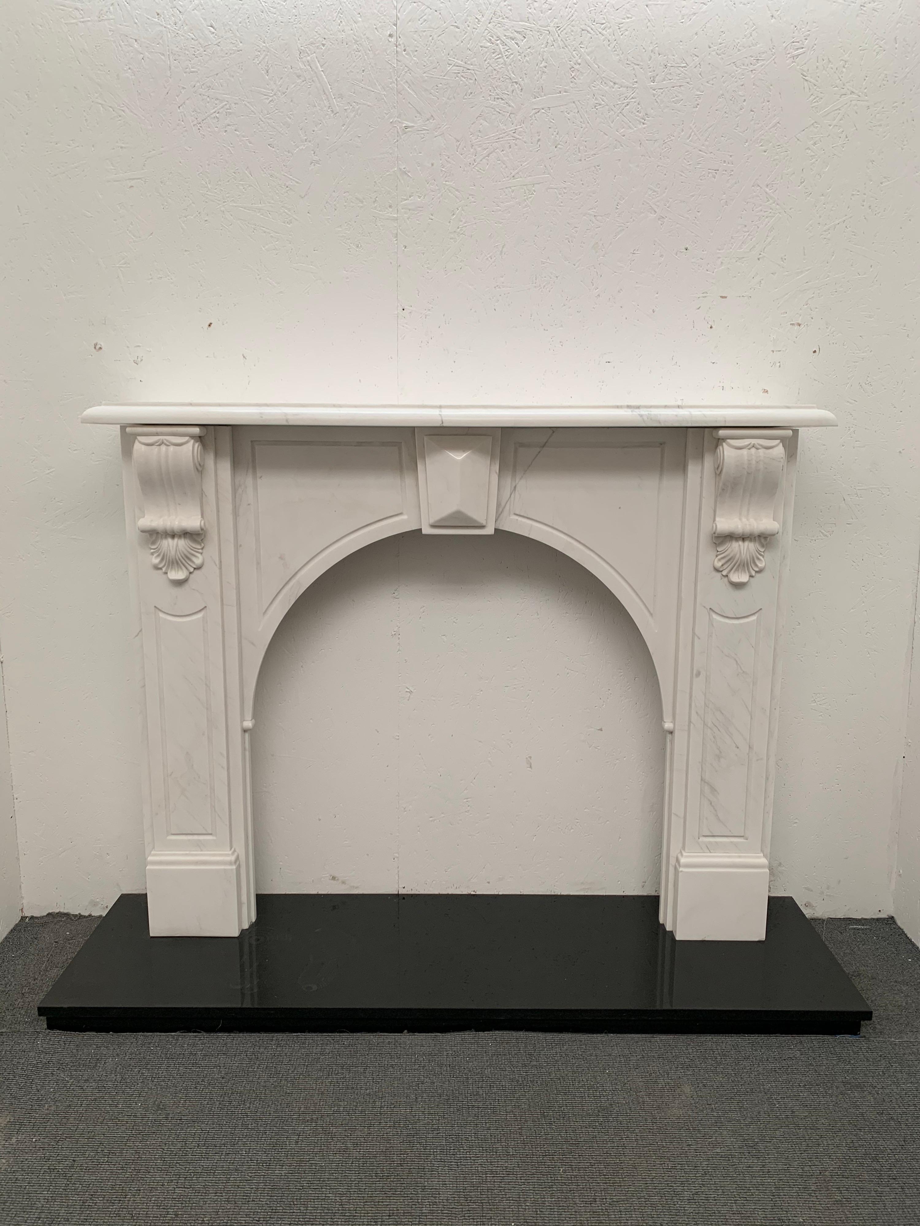 20th century Victorian styled arched carved corbel mantelpiece in a statuary white marble.
Finely hand carved corbels with centre tablet, semi bullnose shelf in traditional honed finish.
Minor fractor to the frieze as veinage but in good