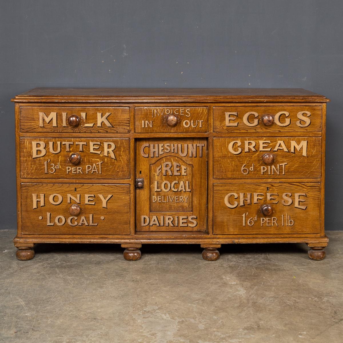 Antique early 20th century Victorian pine credenza, later painted to advertise the wares of a local dairy / grocer shop, where the piece might have been used as a counter. This useful and attractive sideboard features 7 drawers and a small centre
