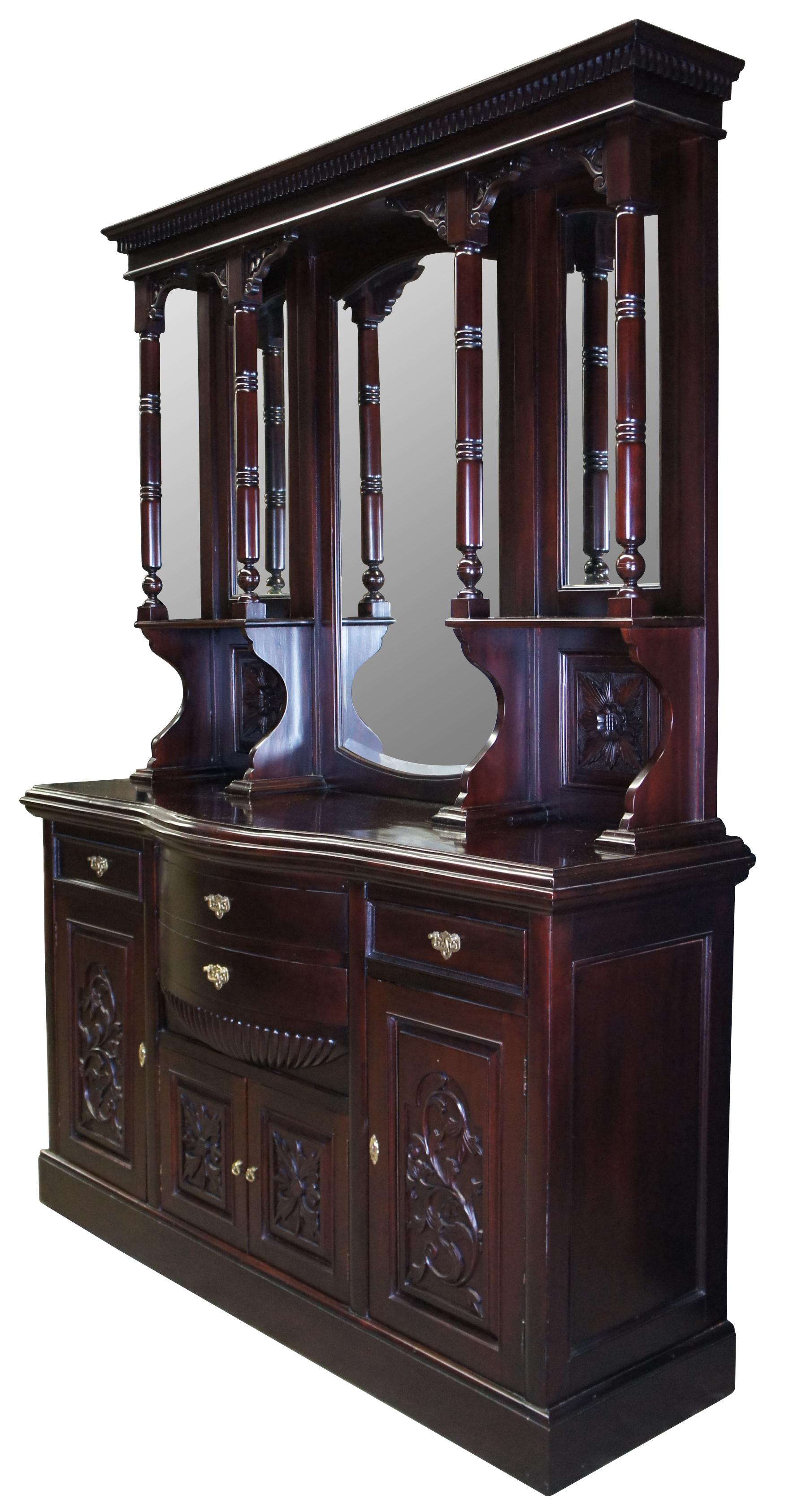 Victorian Revival Buffet and Hutch, circa 1980s. Made from mahogany with a bowfront, 4 dovetailed drawers and lower cabinets for storage. Hutch features beveled mirrors and four full columns with ribbed accents leading to shelves. Includes foliate
