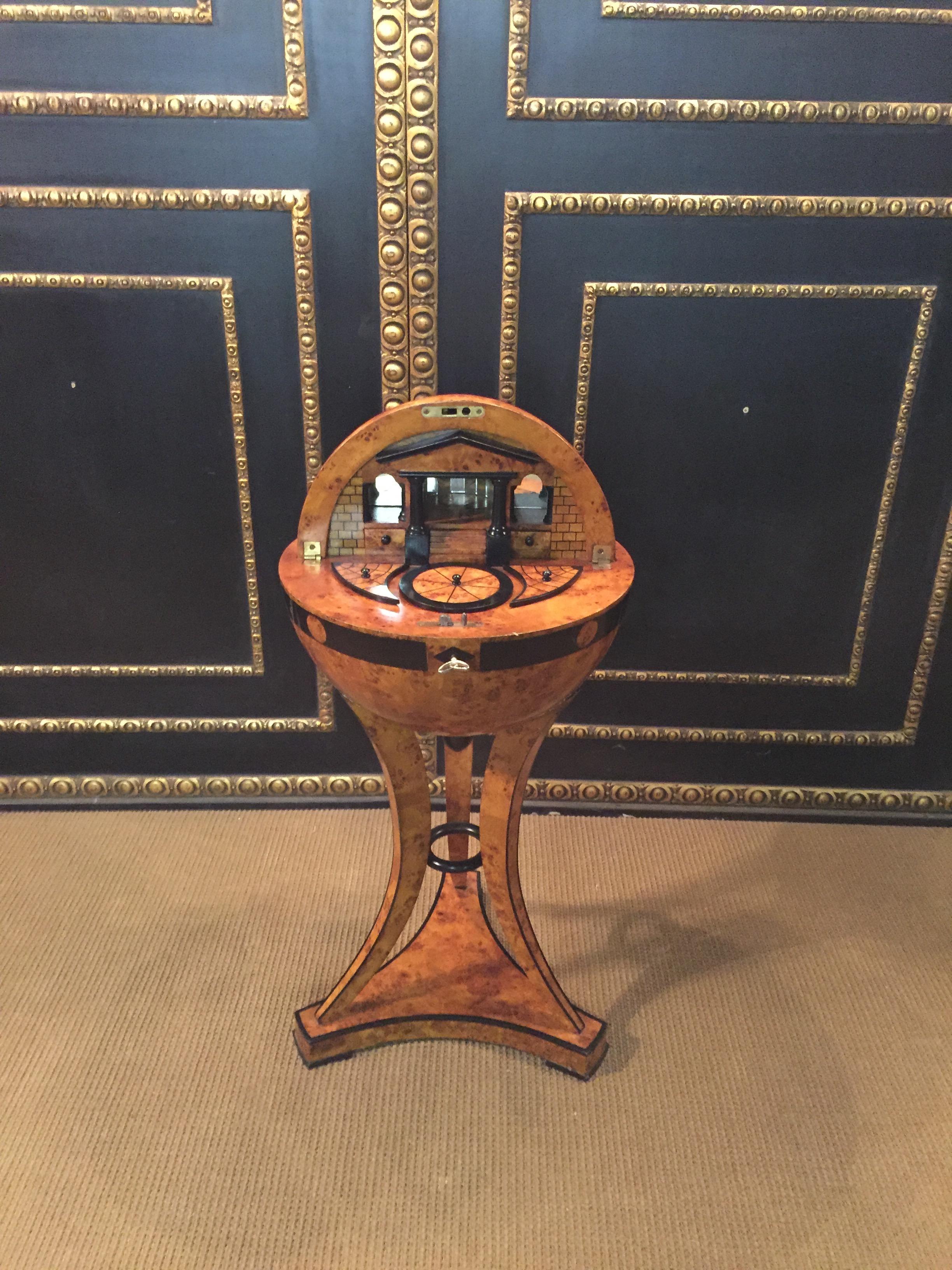 Highly significant globe sewing table in Vienna Biedermeier style. Bird’s-eye maple root veneer on solid beech, partially ebonized, with inlays.