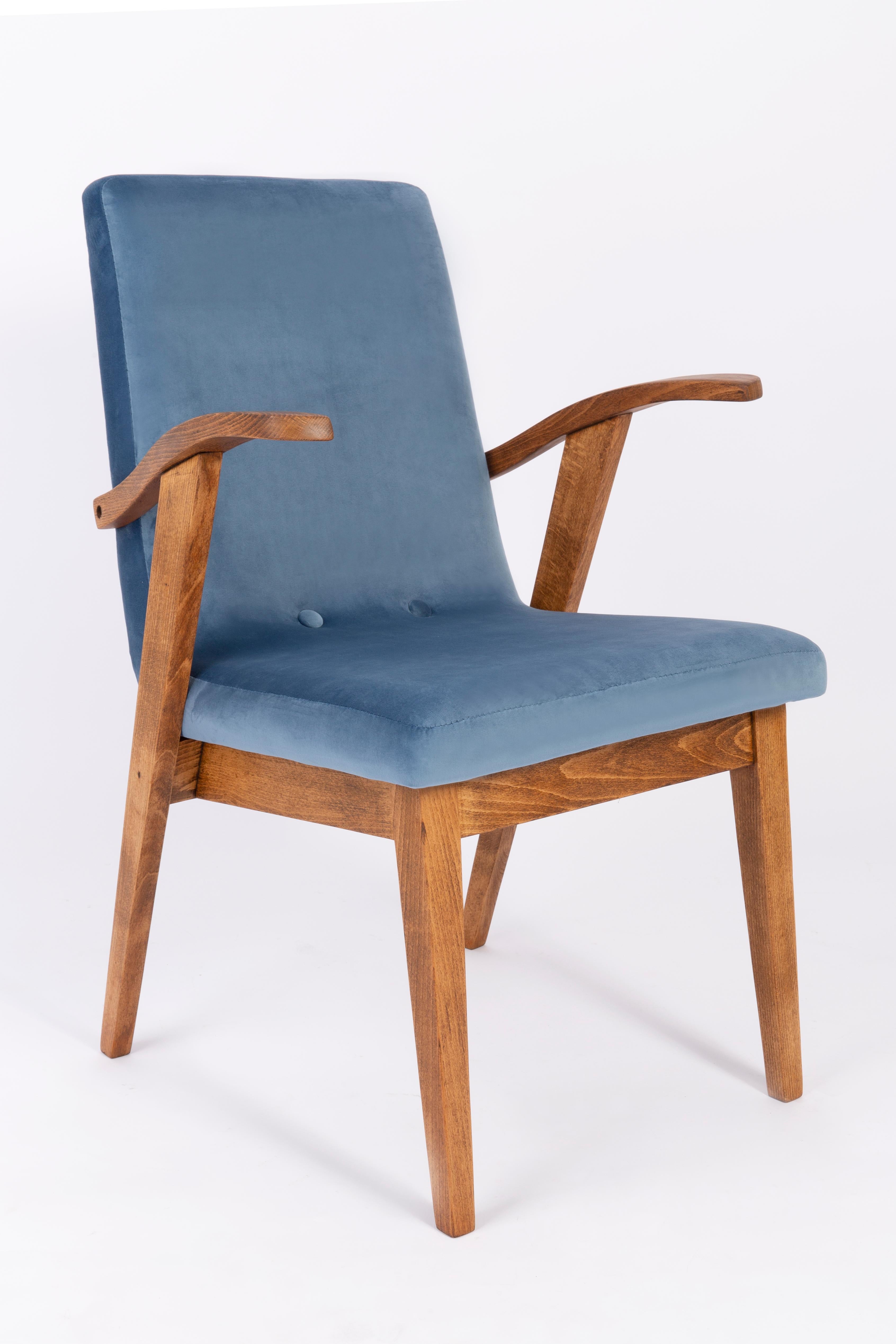 Armchair designed by Mieczyslaw Puchala in a classic edition. Medium brown wood combined with a gray blue (color 2233) fabric gives it elegance and nobility. The chair has undergone a full carpentry and upholstery renovation. The wood is in