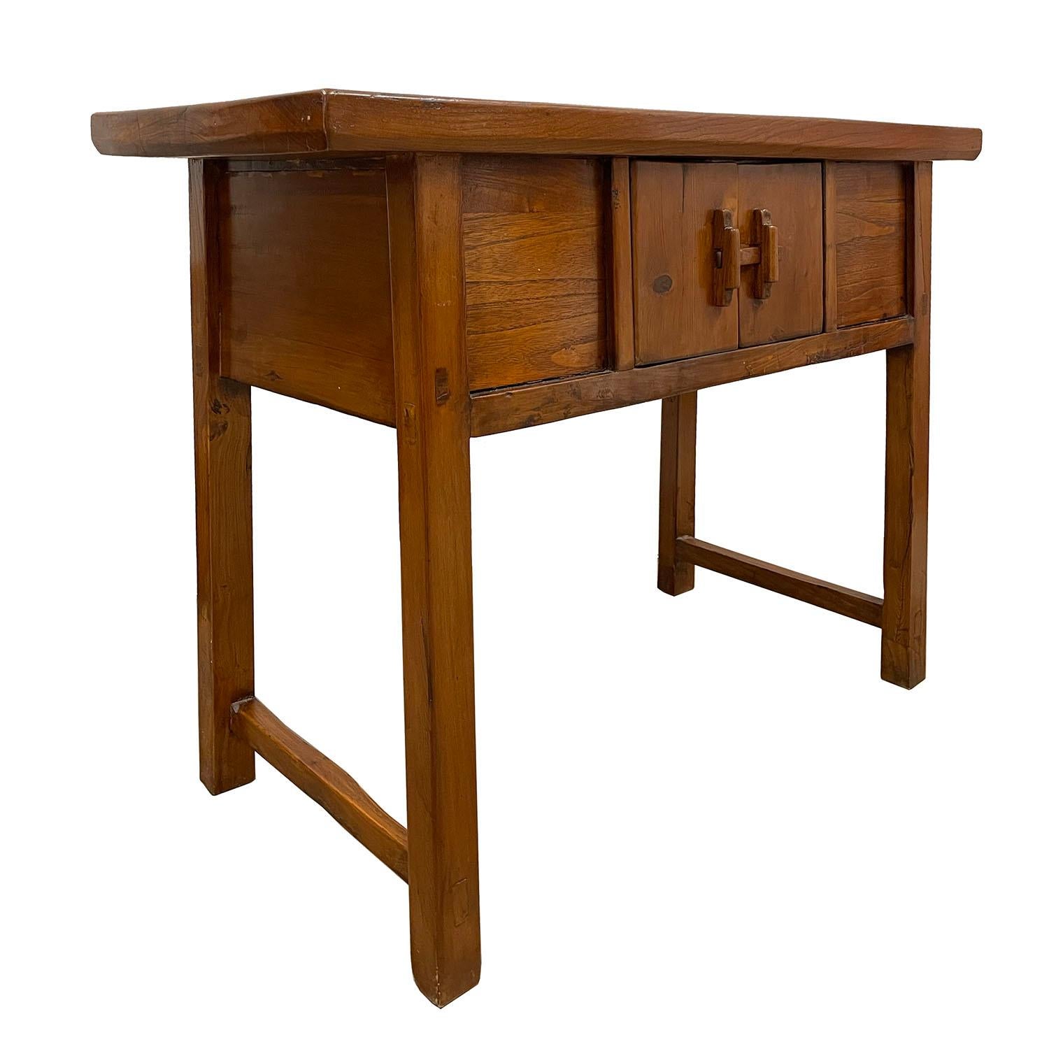 This beautiful vintage console table has beautiful traditional Ming style simple country design. It features double open doors compartment on the front. Both sides and back are finished. This table was made at about 1950's using solid elm wood. The