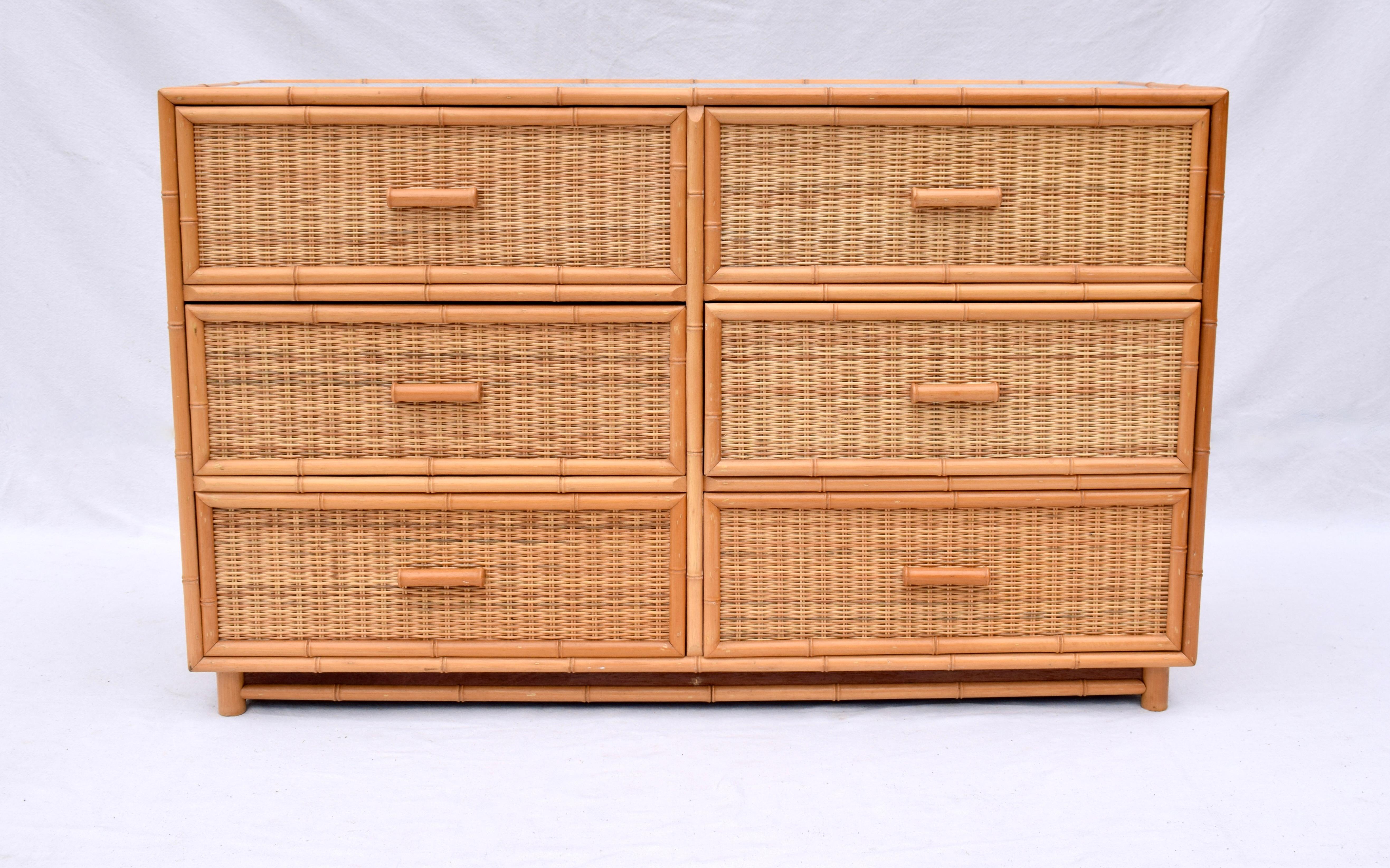 A vintage Coastal six drawer dresser of woven rattan panels, carved bamboo trim & custom glass top. A single matching nightstand can be viewed in our separate listing:  